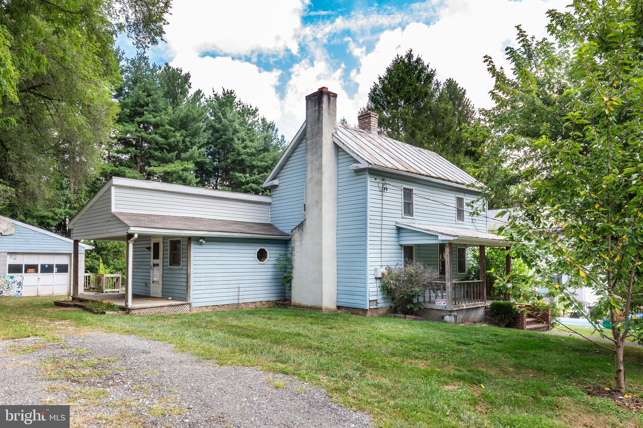 Sold strictly as-is. Home is habitable on first floor but will need work on 2nd floor. Pass thru bedrooms on 2nd floor and also a full attic. Original home dates to late 1800s w/ an addition in the 1990s. Both old and new have basements. If you are someone with home improvement skills and can tackle deferred maintenance inside and out, this might be the project home for you. Kitchen, living, dining and family room on main level with the primary bedroom, bathroom and laundry. Main floor bedroom has a French door to the deck. Brick fireplace wall in living room and corner brick hearth for woodstove in dining room with slider to deck. Nice quarter acre yard with mature fruit trees, older above ground pool and 2 car detached block garage.