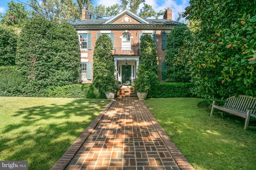 This stately 1927 Georgian Revival is located on a highly desirable street in the sought-after Wesley Heights neighborhood. The beautiful house is set back from the street behind a row of manicured hedges, providing wonderful privacy. The impressive home sits on over half an acre lot, with beautifully designed gardens and a pool. The charming interior features generously proportioned entertaining rooms, as well comfortable family living spaces, professionally designed by William Hodgins. The elegant rooms are light-filled, with an abundance of natural sunlight coming from large windows throughout. There is also the added convenience of an elevator to three floors. The magnificent reception foyer features handsome moldings and cornices, as well as intricately detailed wood floors. The entry foyer seamlessly transitions to the sophisticated living room, which offers a lovely central fireplace with an eighteenth-century French limestone mantle, attractive arched transom windows, and French doors to the terrace. The neighboring dining room, which can also be accessed from the reception foyer, is exceptionally scaled and enhanced with thick crown moldings. The dining room provides direct access to the enchanting sunroom, which provides a garden ambiance and is fully windowed on three sides, affording stunning views of the rear garden and lovely water feature. The gourmet kitchen offers a large center island with a breakfast bar, abundant cabinetry storage, and a Viking six-burner range. There is also an elegant library on this floor, which has an additional fireplace and a convenient powder room. Completing the main level is a side entrance that provides access to a bedroom suite, nanny’s bedroom, the one-car garage, and the lower level. The second level has three bedrooms and three full bathrooms, including the gracious primary suite. The primary bedroom is well-appointed with a private balcony, en-suite bathroom, and a generous walk-in closet. There is also an adjoining sitting room, complemented with a fireplace and built-in bookshelves. The two additional bedrooms on this floor are both spacious and have en-suite bathrooms. The third floor provides a large open flexible-use space with an impressive roof deck. The room is currently being used as a bedroom, providing a large walk-in dressing room and an updated full bathroom. The lower level has a family room with built-ins, a secondary kitchenette with a breakfast bar, multiple large storage rooms, a sizable laundry room with a utility sink and storage, and a full bathroom with a frameless glass shower.  This extraordinary residence is exceptional for entertaining with multiple terraced seating areas, a pool, water fountain feature, rear yard, mature trees, and lush professional landscaping. The house is within walking distance to neighborhood favorite restaurants, shops, and parks.