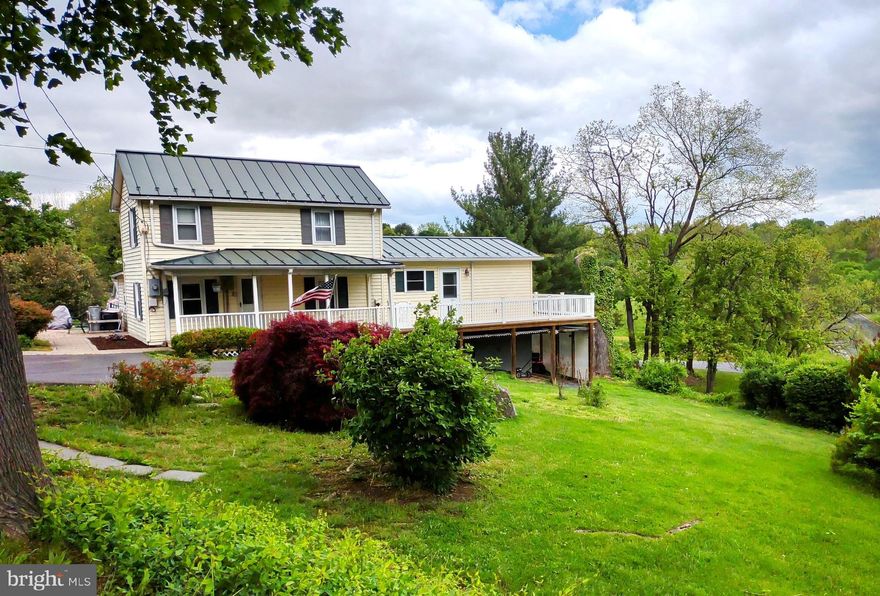 BACK ON THE MARKET!   BUYER FI NANCING FELL THROUGH!   COUNTRY ROADS WILL TAKE YOU HOME to this delightful farmhouse style home that is situated on 2.09 park like acres in Historic Woodstock! Let the stress of your busy day disappear as you relax on your wrap around deck and enjoy your sprawling yard with birds, squirrels, trees, and flowers. As you enter the front door, you can feel the relaxation continue. The living room is cozy and the eat-in kitchen with its numerous custom-built cabinets will be the focal point for sharing your day’s activities with others. The main level also offers you an "in-law suite" or your own private solitude away from the bustle of the rest of the house. Upstairs there are three bedrooms and a full bath for the other family members. Whether you want to have a cookout or watch the starlit sky, you will have the pleasure of enjoying both on your stone patio with its lovely fountain.   There is a wet weather creek on the lower end of the property.  That is in flood zone A.  The rest of the property is in flood zone C. Property sold "as is"  Woodstock W O Reilly Park nearby.  The year the house was built is unknown.