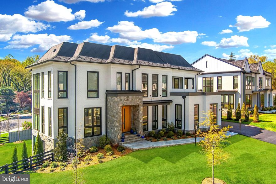 Welcome to Onewood at Halls Manor – the crown jewel of McLean’s premier new construction community. With over 10,300 sq ft of total living space, including multiple outdoor living areas, this home redefines luxury in a neighborhood set within one of Northern Virginia’s most discreet and sought-after enclaves.

Thoughtfully designed by Premier Homes, this 5BR, 7BA showpiece blends modern and transitional architecture, with soaring 11-ft ceilings on the main level and 10-ft ceilings on both upper and lower levels. Massive floor-to-ceiling windows flood the interior with light, highlighting the home’s custom finishes, wide-plank hardwood flooring, and sleek architectural lines.

The heart of the home is a dramatic, light-filled gathering space anchored by floor-to-ceiling windows and seamless transitions to the outdoors. From the living and dining areas, a retractable screened porch with a double-sided fireplace and full outdoor kitchen with Deckton countertops extends your living space into the landscape—ideal for everyday relaxation or elevated entertaining. Inside, the gourmet kitchen stuns with a 3 inch quartz waterfall island, 6-burner gas stove with pot filler, dual dishwashers, and prep pantry with separate sink.

Upstairs, 4 generous bedrooms surround a gallery-like hallway with designer ceilings. The Owner’s Suite is a sanctuary—complete with private terrace, sitting room, wet bar, two water closets, dual walk-in closets (one with an island), and a spa-style bath featuring a combined glass steam shower and soaking tub.

The lower level walks out to a stone terrace with yet another full outdoor kitchen and a custom fire table—perfect for entertaining. Inside, enjoy a full wet bar with beverage fridge, tasting room, gym, spa, and the kind of light-filled lower level that feels nothing like a basement.

Additional highlights include a discreetly integrated elevator, a fully fenced backyard enhanced by mature privacy landscaping, Phantom retractable screens, premium Pella windows, and epoxy-coated garage floors. Every inch has been designed for someone who’s seen it all… and is finally seeing what’s next.

Halls Manor offers an unbeatable location—just minutes from downtown McLean, Tysons Galleria, and Metro access, with seamless connectivity to Washington, DC, renowned schools, and the region’s top destinations.