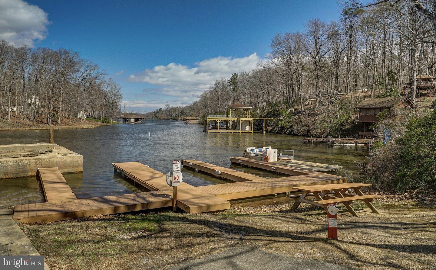 Beautiful lake access lot at Lake Anna, Virginia! Located in Pine Harbour, a gated community on the public side of the lake that offers unparalleled beauty in a peaceful setting. Bring your builder, your dream home plan and start building your next home on this beautiful 1.20 acre lot that is currently wooded. Take a short golf cart ride or walk down to the waterfront community common area where you'll enjoy boat slips, a boat ramp, gazebo, and a covered picnic area. Great location on the lake and convenient to local dining, groceries, and more. Whether you're seeking to build your dream home, investment property or weekend getaway, this will be the perfect place to start living the lake lifestyle. Short term rentals are permitted in Pine Harbour! Boat slips are leased on a yearly basis and there are also several boat slips available on a first come, first serve basis that are not leased.