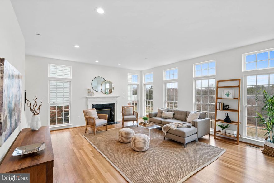 Designed and built by NV Homes in 2001, this move-in ready brick colonial boasts 5,400 square feet over three light-flooded levels with spectacular treetop views for miles.  This turn-key gem has just completed a full refresh with newly installed hardwood floors, fresh paint, state of the art LED recessed lighting, designer carpeting, and on-trend light fixtures. 
 
The soaring two-story foyer welcomes you home with gracious warmth and you immediately take notice of the ideal floor plan for how we live and work today. The open layout includes a dedicated office space with a bay window, an expansive formal living room flooded with natural light, and a formal dining room with a tray ceiling that is perfect for entertaining. The open-concept continues into the kitchen with ample counter space and an additional informal dining area that flows seamlessly out to the deck for al fresco dining and grilling under the stars and long range tree top views. The adjacent family room with floor to ceiling windows has new hardwood floors and a cozy fireplace with a lovely dentil molding mantle.  A dedicated oversized laundry room and newly renovated powder room round out the main floor.
 
Two staircases lead you to the upper level with a primary suite that is a true retreat with a seating area, walk-in closet, and beautifully appointed primary bathroom with a soaking tub, standalone shower and double sinks.  Four nicely sized additional bedrooms and a hall bath complete the spacious upper level. The walk-out lower level spans over 1,300 square feet with a full bathroom, recreation area, and storage galore. Don't miss the convenient attached two car garage.  Conveniently located close to community and retail amenities yet nestled in a serene setting with sunset and treetop views.  Located in the blue ribbon Wooton High School cluster. Welcome Home!