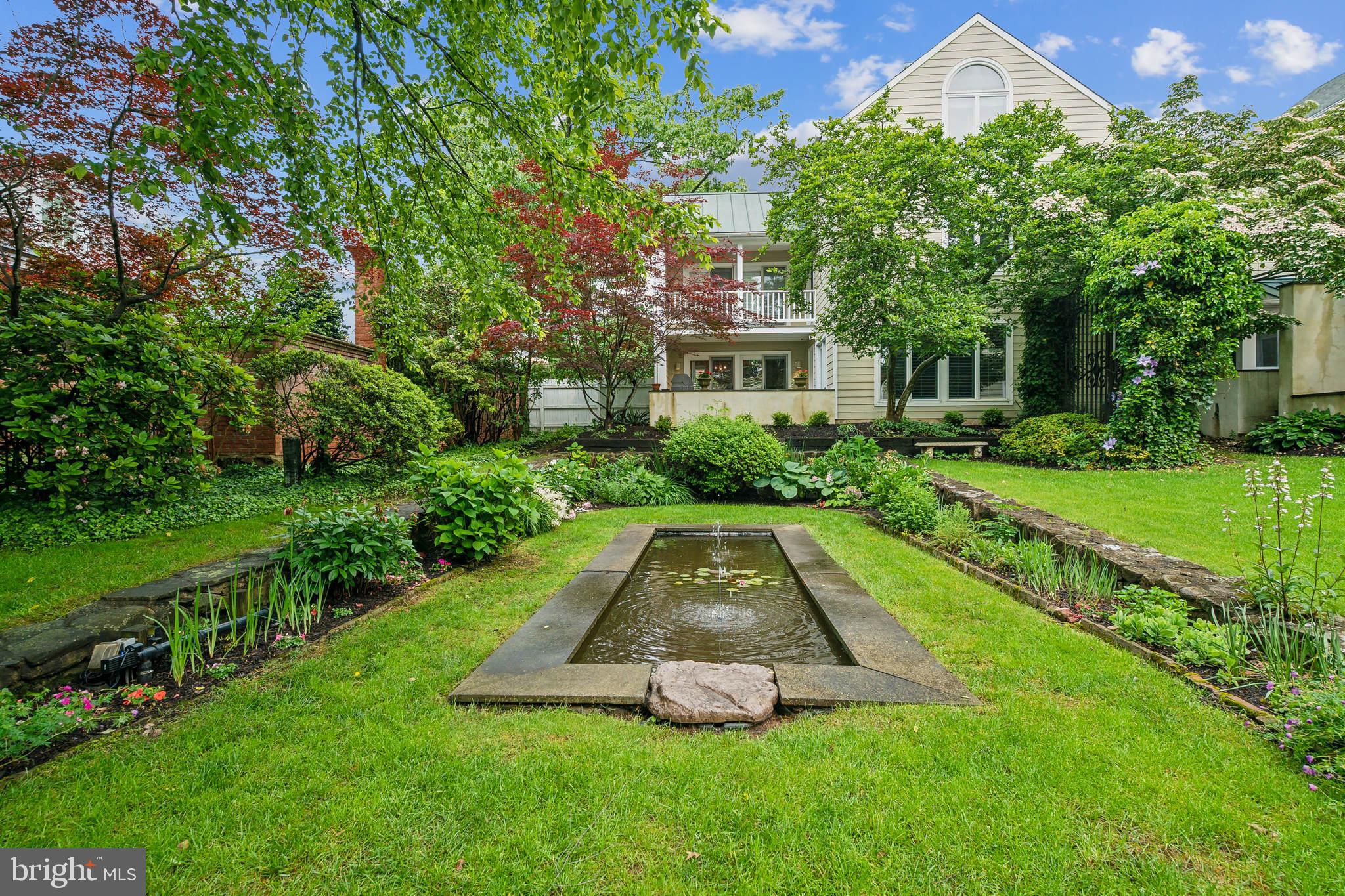 Located on a premier lot in the Barnes Court community, this home is the ultimate in Doylestown Borough living. The ten homes in this peaceful community are tucked off Garden Alley and clustered around an enchanting courtyard; what is so special about this home is that the courtyard, its lush gardens, and koi pond are showcased from almost every window. Thoughtful updates can be found in every room, including the living room's richly-detailed coffered ceiling and dual casement Anderson windows. A natural Bucks County stone wall graces the dining area. Large glass doors from both the living room and the dining area lead you to a 13'X13' brick patio with classic half wall making for a secluded oasis to enjoy many a summer barbeque. The completely updated kitchen is every gourmet cook’s dream as it features top-grade stainless-steel appliances, gas cooking, sophisticated pendulum lighting, cabinet lighting, attractive glass door cabinets, a breakfast bar and granite countertops. The primary bedroom offers crown molding, a large closet and an updated bath and has access to a deck which would be a tranquil spot to enjoy your morning coffee. The 2nd bedroom, also with crown molding, has two closets and access to this same back deck. A stackable laundry closet completes this 2nd floor. Ascending to the 3rd floor you will find another bedroom boasting an 11'X11' walk-in closet; this bonus space could be used as a sitting area, study or renovated into a new luxury bath to make another primary bedroom. This 3rd bedroom with a cathedral ceiling and eye-catching arched window would be an ideal location for a quiet work-from-home office, library or exercise space. Highlights include a distinctive foyer and powder room granite tile flooring, warm hardwood flooring in the living, kitchen and dining rooms, tall and large windows galore, new roof (2024) and a full unfinished basement. Two parking spots are allotted for this home - one designated covered space and one parking lot space. In the heart of historic Doylestown, it is a quick walk to the popular eateries, quaint shopping, library, courthouse and museums. The train to Philadelphia is minutes from this property as is Route 202 which will take you to Peddler's Village, New Hope, and New Jersey. Beautiful Peace Valley Park is only 4 miles away. The new homeowners will have the comfort of knowing America’s Preferred One Year Home Warranty is included. Impeccably maintained and a pleasure to show.