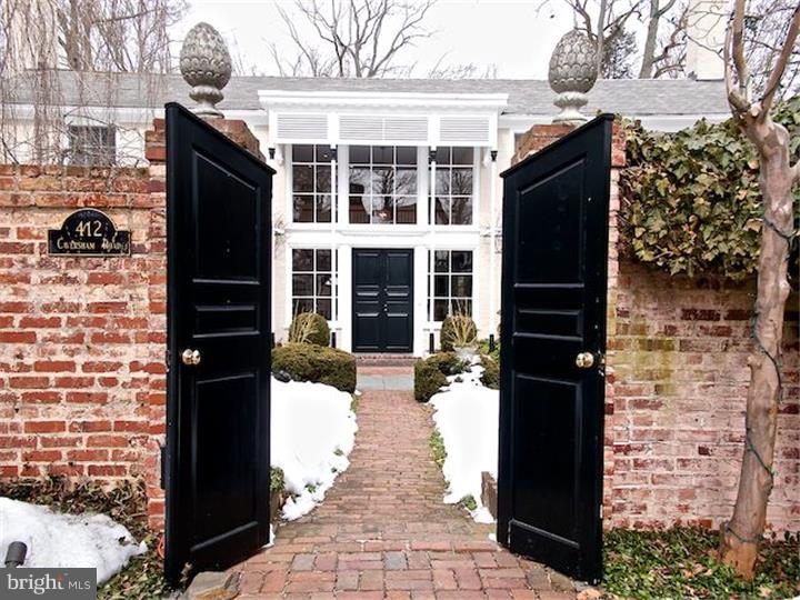 One of a kind property designed by Walter Durham sits on a delightful acre plus of lawns and gardens. The bright and open design will delight, tucked away at the top of a hill, but within minutes of SEPTA station, stores and shops, and the beautiful campus of BM College as well as Historic Harriton House close by. The cobblestone and brick forecourt with mellow brick walls lends European flair. Wrought iron gates protect the driveway which leads to the detached two car garage, with studio apartment with full bath & kitchenette above, useful for inlaws, guests or aupairs. Enter the house under a rose arbor to soaring ceilings overlooked by a 23' art gallery, bathed with natural & custom lighting. Living room with wood burning fireplace set in a paneled chimney breast with bookshelves. Coat closets and PR, study with big windows and raised log fireplace. Antique brick-floored dining room with two leaded pane glass doored cabinets. Entertain in the heated Florida room with tall window walls, intricate brickwork & slate floor opening to the elegant patio and pool area. Marvellous for plants, parties or just cooling off. Beyond the pool, there is a walled Japanese garden with many specimen trees and plants. Modern kitchen with granite countertops has all the amenities. You can work with or watch the cook in the sun-filled space. Desk area and access to basement. Outside entrance to brick breakfast patio leads to garage. Step down to a bright family room with eating area and wood burning stove. Outside entrance to the pool and spa. The floors are tiled and there is room for a ping pong table. Full bath and laundry room. A floating staircse rises via second floor gallery leading to the E.B. Mahoney updated master suite with large bedroom overlooking the pool and grounds, dressing area, large walk in closet and spacious modern bath with separate shower and tub. Second bedroom with private bath. Third and fourth bedrooms share an updated Jack and Jill bath. There is a study/TV room with storage and built-ins. Linen closets. Opportunity to own a romantic, manageable mini-estate in a top drawer neighborhood.