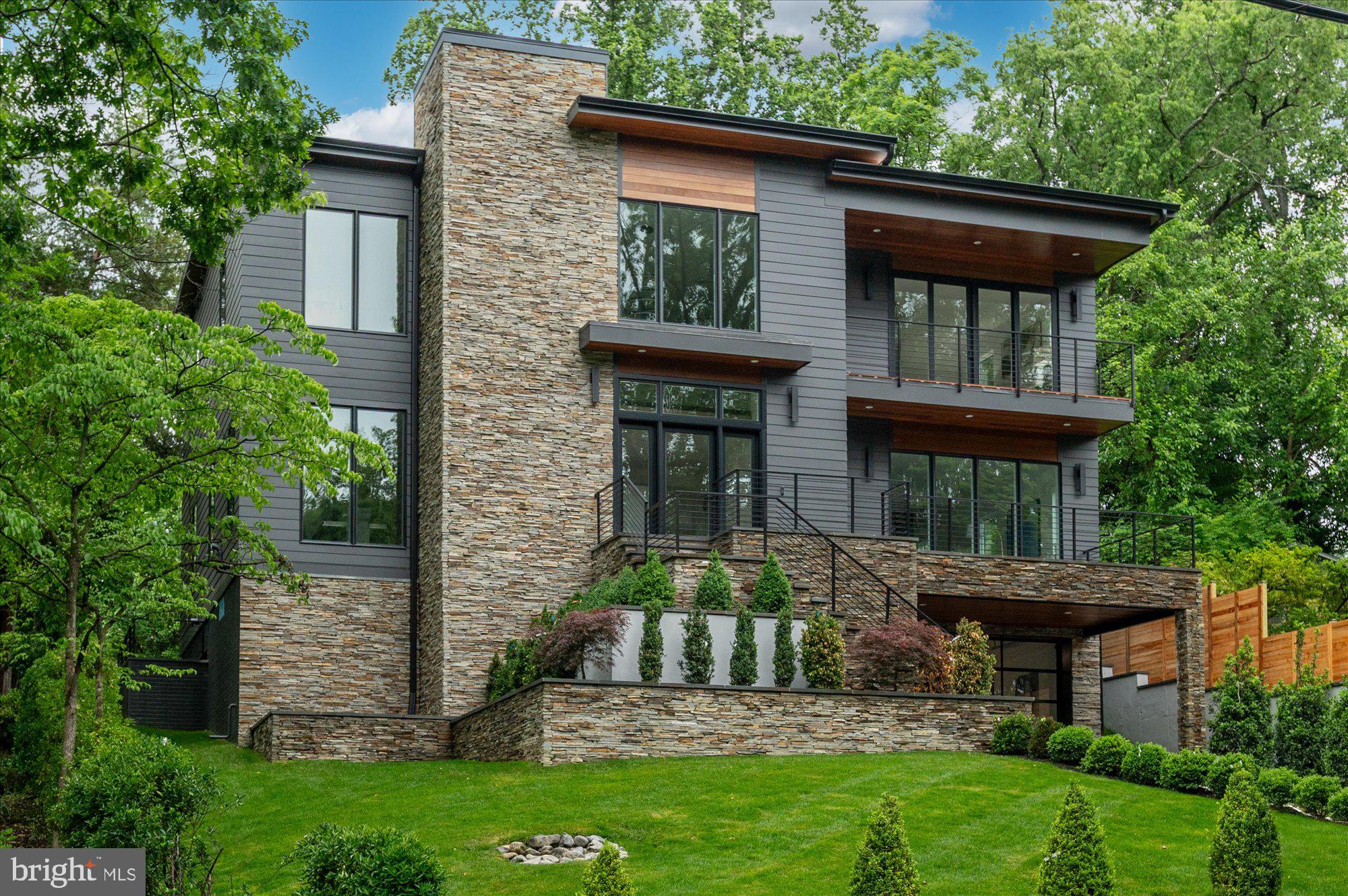 Welcome to this stunning contemporary single-family home located at 5313 Iroquois Rd, Bethesda, MD, in the sought-after Glen Echo Heights neighborhood. This exceptional residence boasts five spacious bedrooms and five and a half luxurious bathrooms. The open and airy design is accentuated by oversized windows, allowing natural light to flood the interior and highlight the beautiful hardwood floors throughout.
The heart of the home is the luxurious chef’s kitchen. Enjoy casual meals at the breakfast bar or in the cozy breakfast nook. The kitchen also features a large island, windowed views, and ample pantry space, catering to all your culinary needs.
Relax in the living area with a gas fireplace, perfect for cozy evenings. The primary ensuite offers a sanctuary with a separate shower, soaking tub, and double vanities. Custom closets in each bedroom provide generous storage options.
Step outside to your private patio and professionally landscaped back yard, ideal for outdoor entertaining or a peaceful retreat.
Additional features include a full basement with a home gym, a guest bedroom and full bath, extra storage space, and an attached garage for convenience. This magnificent home combines luxury, comfort, and modern amenities, making it a perfect choice for discerning buyers. Don’t miss the opportunity to make this exceptional property your new home. All of this located in the Whitman School Cluster, blocks to the shops of Sangamore and less than 5 miles to Palisades, Friendship Heights, and Bethesda Row Restaurants.