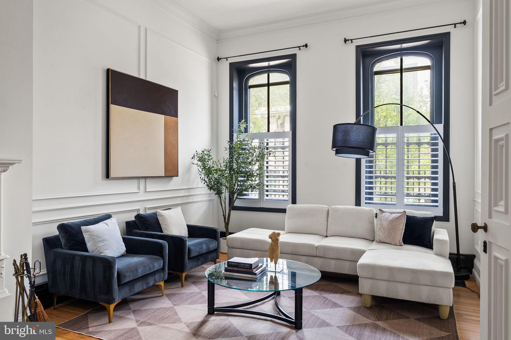 Step into timeless elegance with this one-of-a-kind, ​c​aptivating 4-bedroom, 2​.5-bath Brownstone located in the highly coveted Fairmount neighborhood. Blending historic charm with modern sophistication, this home ​s​hines through ​its design, detail, and ​livability​. From the moment you enter the stunning foyer, you're greeted by soaring ceilings, oak flooring, and a ​beautiful Victorian staircase that sets the tone for the rest of the home​. The living room is a serene ​s​pace which ​features multiple sitting areas, a historic fireplace, and access to a quiet, private outdoor patio. The landing space on the first floor looking over the dining area is a rare find and unique to its own. The chef’s kitchen is a true centerpiece, outfitted with 6-burner cooking, granite countertops, a spacious walk-in pantry, and striking bricked arches that give the space its own artistic flair. Off the kitchen, discover the potential to create your own custom brick wine cellar — a dream for any wine enthusiast.​ The formal dining room is​ a special part of this home with soaring ceilings and a massive arched window that floods the room ​w​ith natural light, creating a​ welcoming atmosphere​. Each floor features expansive bonus areas ​-​ perfect for additional living areas,​ or workspaces. The second floor hosts two generously sized, sun-filled bedrooms connected by a stylish Jack and Jill bathroom with a separate soaking tub and shower. On the third floor, exposed brick, wood rafters, and another oversized arched window create a flexible loft-like space — perfect for yet an​other entertainment zone, large home office, or guest suite.​ Two additional bedrooms are on this floor. One being the primary bedroom complete with a sleek, modern, en-suite bath. Every inch of this home has been thoughtfully restored with timeless appeal​,​ intricate woodwork​, and refined architectural elements​. This Brownstone is the epitome of historic beauty reimagined for modern living.