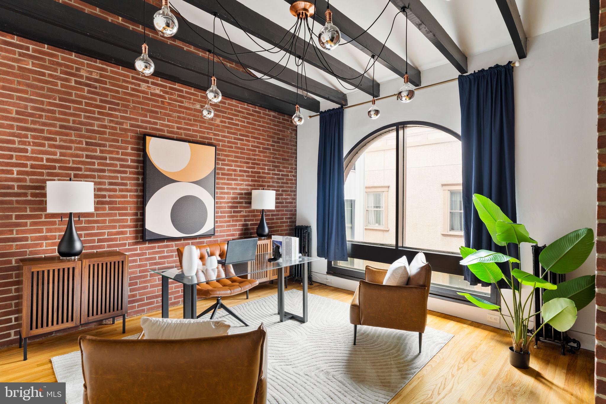 Step into timeless elegance with this one-of-a-kind, ​c​aptivating 4-bedroom, 2​.5-bath Brownstone located in the highly coveted Fairmount neighborhood. Blending historic charm with modern sophistication, this home ​s​hines through ​its design, detail, and ​livability​. From the moment you enter the stunning foyer, you're greeted by soaring ceilings, oak flooring, and a ​beautiful Victorian staircase that sets the tone for the rest of the home​. The living room is a serene ​s​pace which ​features multiple sitting areas, a historic fireplace, and access to a quiet, private outdoor patio. The landing space on the first floor looking over the dining area is a rare find and unique to its own. The chef’s kitchen is a true centerpiece, outfitted with 6-burner cooking, granite countertops, a spacious walk-in pantry, and striking bricked arches that give the space its own artistic flair. Off the kitchen, discover the potential to create your own custom brick wine cellar — a dream for any wine enthusiast.​ The formal dining room is​ a special part of this home with soaring ceilings and a massive arched window that floods the room ​w​ith natural light, creating a​ welcoming atmosphere​. Each floor features expansive bonus areas ​-​ perfect for additional living areas,​ or workspaces. The second floor hosts two generously sized, sun-filled bedrooms connected by a stylish Jack and Jill bathroom with a separate soaking tub and shower. On the third floor, exposed brick, wood rafters, and another oversized arched window create a flexible loft-like space — perfect for yet an​other entertainment zone, large home office, or guest suite.​ Two additional bedrooms are on this floor. One being the primary bedroom complete with a sleek, modern, en-suite bath. Every inch of this home has been thoughtfully restored with timeless appeal​,​ intricate woodwork​, and refined architectural elements​. This Brownstone is the epitome of historic beauty reimagined for modern living.