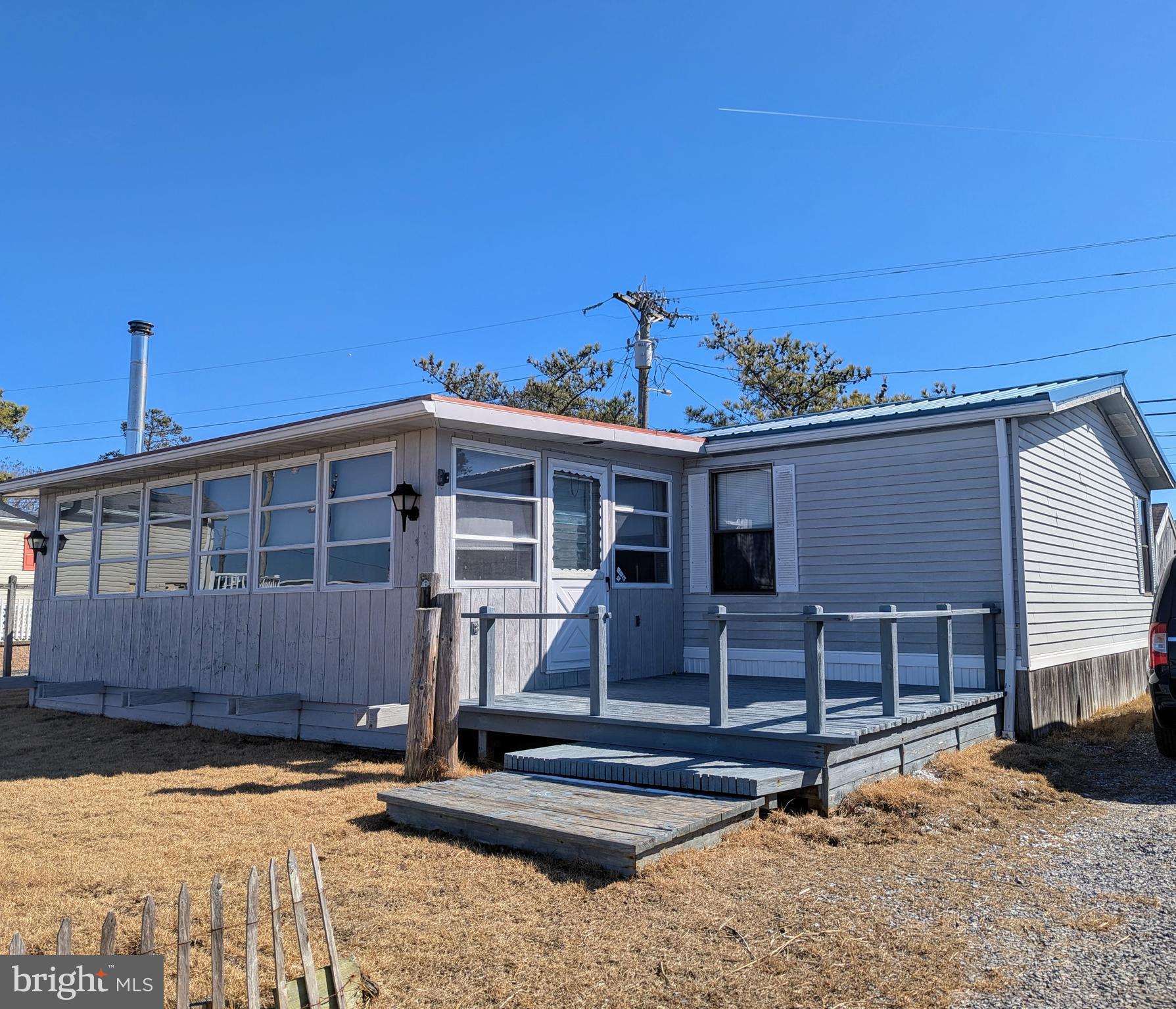 Beautiful water view location in Bay City with doublewide home including a bonus Sunroom facing Rehoboth Bay! This is your ultimate beach home destination if having a great home with a Bay view is in your plans this year. The home features three bedrooms, two full baths with large central Living Room and all furniture as shown. The large addition has a wood stove for chilly nights and days, and window Air Conditioning unit for summer comfort, and the house offers over 1500 square feet of living space. The Kitchen is fully operational with Propane Gas Range, Fridge, Dishwasher, Microwave and double stainless sink! All three large Bedrooms have walk in closets, so lots of storage space for all your beach needs! The separate Utility Room has a full size washer and dryer and a door to the back and shed. The view across the Bay is wonderful, and you can see the back Bay side of Dewey Beach in the distance! Lot rent is $988 per month including trash/recycle pick up.