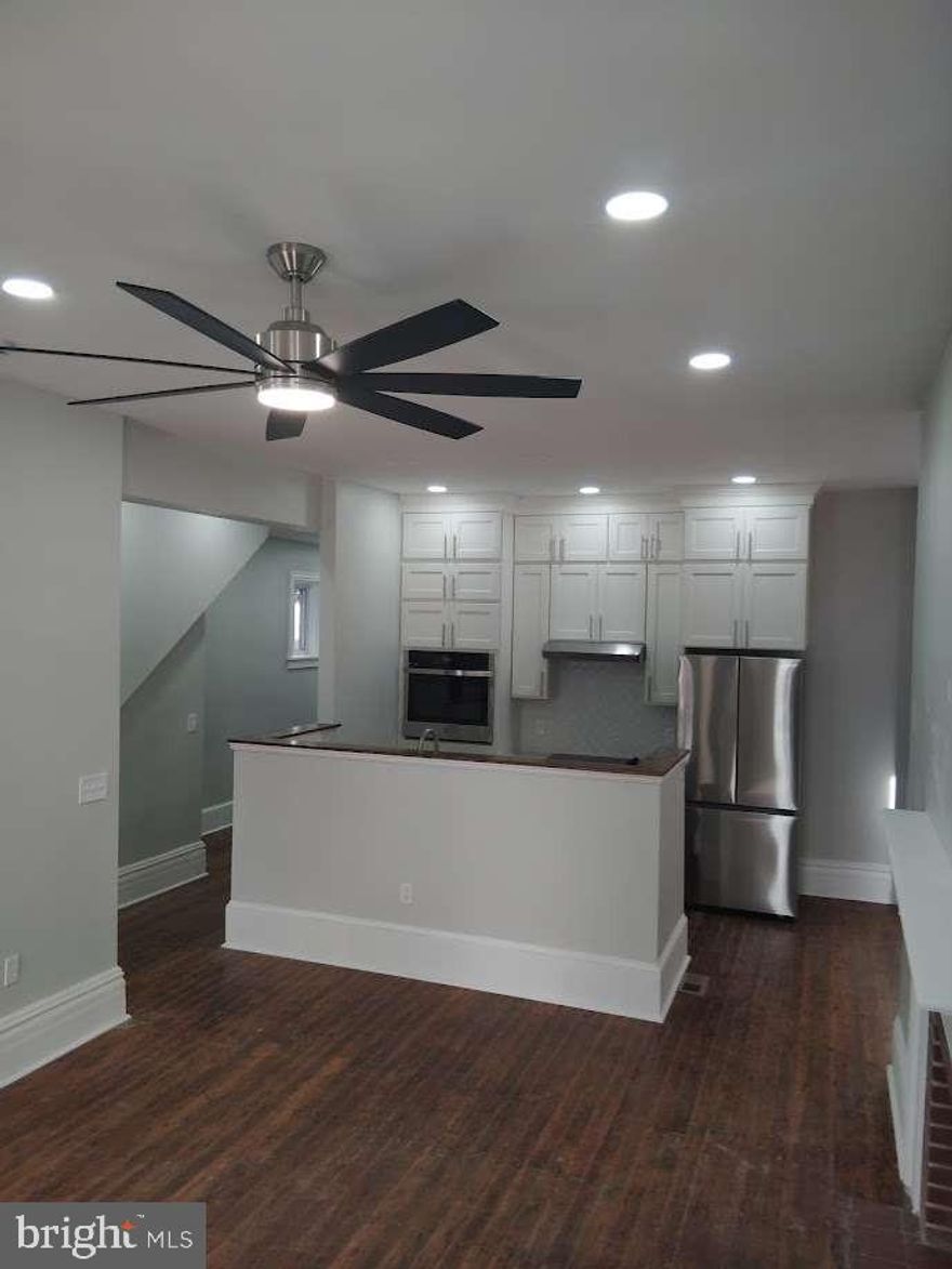 Start planning your move now in the historic Pottstown district! Conveniently located near parks, recreational spaces, and local restaurants, this fully renovated brick colonial duplex offers 3,716 sq ft of beautifully updated living space and endless possibilities. Whether you choose to live in one unit and rent the other, or enjoy the property as a spacious multi-generational home, each unit offers both private and optional common access. Entering through the original 8-foot walnut double doors, you’ll find a home that seamlessly blends modern upgrades with classic charm. Hardwood flooring extends across both the first and second floors. The first-floor unit features two bedrooms and two and a half bathrooms. The updated kitchen includes stainless steel appliances, a wall oven, 42-inch custom cabinetry, a granite island, and a cozy breakfast nook. The expansive family room offers recessed lighting, a ceiling fan, a faux fireplace, and floor-to-ceiling windows overlooking an impressive 250 sq ft wrap-around porch accented by pendant lighting. A mudroom and laundry area with a powder room add convenience. The primary suite includes a private bath and walk-in closet, while the second bedroom offers new carpeting and its own full bathroom. This level also includes a private patio and yard, along with access to a detached oversized two-car garage with windows and lighting. The second-floor unit offers two additional bedrooms and two full bathrooms. A bright family room is enhanced by large windows and a ceiling fan. The kitchen includes stainless steel appliances, a laundry area, and direct access to a covered deck equipped with ceiling fans. The bedrooms feature distinctive large windows and ceiling fans, adding to the home's charm and comfort. The third floor provides a flexible space ideal for an additional bedroom, studio, or project room and includes its own full bathroom and multiple windows for natural light. Additional improvements include brand-new windows throughout, two new separate HVAC systems, upgraded 200-amp electric service, a new roof, and a finished basement offering approximately 800 sq ft of extra living space with ample closet storage, windows, and exterior access. The property also includes a large detached two-car garage with a private driveway and lighting. Move-in ready, fully updated, and designed for versatility, this exceptional property is ideal for both homeowners and investors. It truly has it all!