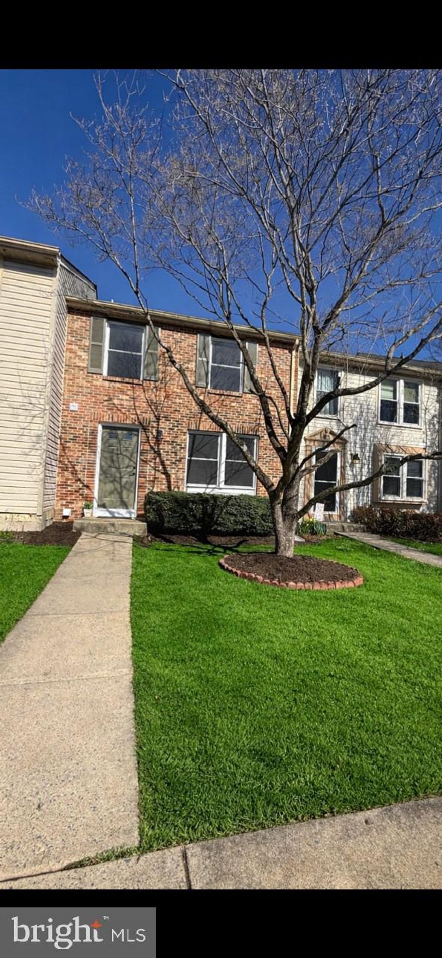 This beautifully renovated three-level brick-front townhome offers modern upgrades in a peaceful, quiet neighborhood. Freshly painted throughout and featuring durable luxury vinyl plank flooring, the home is truly move-in ready.

The main level includes a stylish half bath with tile flooring, a quartz countertop, and updated fixtures. The kitchen is thoughtfully updated with LVP flooring, sleek quartz countertops, and brand-new Samsung smart appliances, flowing seamlessly into a separate dining area—perfect for everyday living and entertaining.

Upstairs, you’ll find three comfortable bedrooms. The spacious primary suite features a dedicated dressing area, a walk-in closet, and direct access to the main bathroom. The full bath is updated with LVP flooring, a tub/shower combination, and a new toilet and vanity.

The finished basement expands your living space with a cozy family/rec room centered around a charming wood-burning fireplace. A convenient kitchenette—complete with a  new bar sink, and cabinet and all new refrigerator, microwave and cooktop—adds flexibility for guests or extended living. The basement also includes a separate laundry room with brand-new washer and dryer, renovated bathroom with a floating vanity and new lavatory. Plus a  walk-out access to a fenced backyard that backs to serene natural surroundings.

Additional highlights include a roof that is approximately six years old and an HVAC system that is just three years old, offering peace of mind for years to come.

A turn-key home combining comfort, style, and convenience—ready for its new owner.