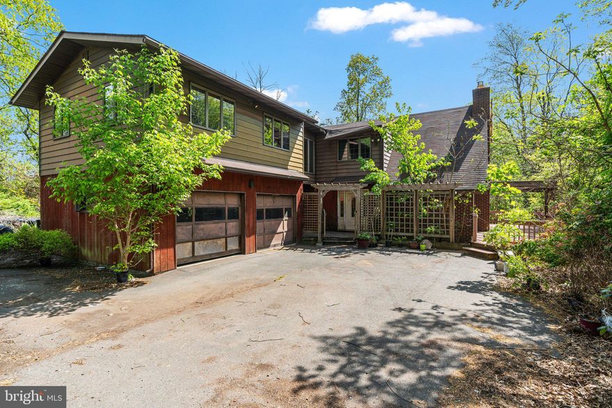 This versatile and spacious home offers great potential and plenty of room to grow including an additional full bath already plumbed. Beautiful brick fireplace in Living Room with soaring ceiling and loft area/catwalk from 2nd floor.  10 x 16 Sunroom off kitchen area.  Ideal for multi-generational living featuring a separate living space above the attached two-car garage—complete with its own private entrance, full kitchen, and bathroom. 2012 roof.
Nestled on 3.87 of mostly wooded acres, this property offers privacy, space, and endless potential. Enjoy the outdoors with large wraparound decking, several sliding glass door entrances, a gazebo, trellises and a garden area perfect for relaxation.
First-floor laundry room for convenience and a spacious walk out basement rec room featuring a wood stove, sink/range.
Huge 30 x 40 Pole barn is approx. 20 years old and in the rear of property.  Whether you're looking for a home to customize or space for extended family, this property is a rare find with room to make it your own!