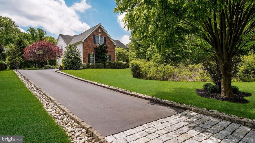 Nestled within Upper Mountain Estates, an executive community with endless miles of sidewalks and mature trees, sits this special home for you.  Prepare to be impressed as you view the home from the street, with Belgian blocks integrated into the driveway that leads you past the woodland and to the view of the handsome brick front exterior of this residence.  The larger size of this lot, combined with the natural woodland, adds to a sense of privacy within this community.  The foyer announces that you “have arrived”, with a center “T” staircase nestled between the living room and dining room.  This dining room is enhanced by additional millwork on the wall and ceiling.  Offering the highest level of flexibility, the living room is an open canvas for a quiet retreat, playroom, homework zone, craft and hobby space… absolutely limitless!  The back of the home is the most popular zone, with three sets of French doors leading to the extensive paver patio and the inground heated pool at the side yard.  A fantastic kitchen awaits and offers all of the details on your list:  stainless steel appliances, granite countertops, island with seating and storage, 6 burner gas cooktop with stainless steel hood, wall oven with convection microwave above, serving station perfect for a coffee and tea nook, a gracious walk-in pantry to keep you organized, large space for a table, and a “command center” desk for all to use.  This kitchen opens to the two-story family room, with a centered wood burning fireplace and plenty of space for your gatherings.  A first floor office with French doors and views of the rear yard and pool can also be a great playroom or teen lair.  The laundry room is tucked away from view and has a utility sink.  Upstairs, the primary ensuite is palatial and includes a large sitting room, sleeping area with tray ceiling, long hallway bordered by closets on each side (WOW!), and bathroom with sizable tile shower, soaking tub, two sink areas with granite counters, private water closet, and a separate make-up vanity.  A second ensuite offers a walk-in closet and full bathroom with tiled tub/shower.  Two additional bedrooms, each with double door closets, share a bathroom with two sinks, separate tub/shower room, and linen closet.  The finished basement includes a full level of great spaces.  The private theater room, large family room, and workout zone will be fan favorites.  A bar area has walls of wood, imported from Africa and recycled from former boats – so unique!  The unfinished area is great for storage and has plumbing for a half bathroom.  Outside, the spacious paver patio has areas for dining, entertaining, and a walkway to the heated inground pool.  The lot continues past the pool, offering another open space for your enjoyment.  Enjoy this lifestyle, so close to major destinations like Doylestown, New Hope, and Newtown, plus major roadways and transportation to Philadelphia and New York.  Your next chapter awaits!