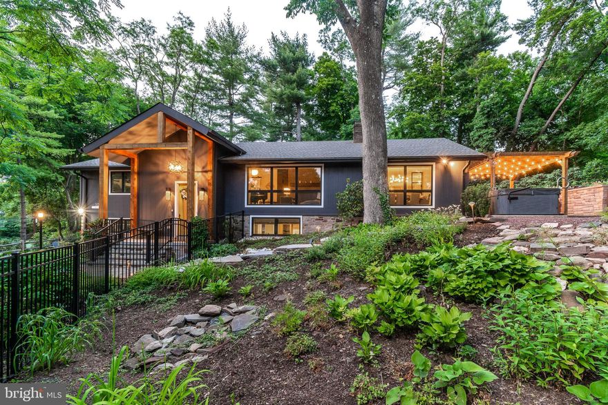 If you're on the hunt for your New Hope dream house, take a moment to appreciate the beauty of this modern farmhouse-style home with a pacific north west twist, that has recently undergone a complete overhaul.  Every detail has been executed with grace and elegance, from the marble tile and white oak floors throughout to the customized closets. The high-end appliances, built-in media centers, and beautiful light fixtures are a testament to the care and attention that went into creating this masterpiece.  Welcomed by a dramatic foyer with stylish marble tile flooring, exposed stone and an elegant fixture above leads to a light filled formal living room featuring a vaulted ceiling, a modern gas, tiled floor to ceiling fireplace with adjacent sleek built-in cabinets and electric shades. The formal dining room is open to the kitchen  and living room, creating an ideal entertaining layout.  Iron and glass stationary windows flank the entrance to the gourmet kitchen, complete with Miele appliances including a 5-burner gas stove top, with hood, wall & steam ovens, dishwasher, wine fridge, a stainless-steel farm sink, coffee bar, pantry, herringbone tile backsplash, banquette seating, and an oversized quartz center island ideal for prep work and serving, is all a cook’s dream! The bedrooms are separated from the public spaces by an impressive contemporary decorative barn door, an elegant upholstered barn door leads to the the main suite boasting a luxurious bathroom with radiant heated floors, a floating quarter sawn oak double vanity, soaking tub and a spacious shower for two, vaulted ceiling, deck access, and a large walk-in closet. The other two bedrooms each have vaulted ceilings, ample closet storage and share an elegant hall bathroom. A sizable laundry room with tile backsplash and flooring completes the main level. The lower level offers a generous family/entertainment space, with the original cozy stone wood burning fireplace, exposed stone walls, two stunning Miele wine fridges, a wet bar, bar fridge, ice maker and a full bath. Outside, you'll find an oasis for outdoor entertaining, a fenced, professionally landscaped, terraced yard with a pergola-topped bluestone patio, a gas fire pit, and a spa. The home renovation also added a 3rd extra garage bay with storage so cars can stay out of sight. All systems have been updated or replaced: HVAC, plumbing, electric, dehumidifier, water softener, full house generator, new windows and doors…the list goes on. This home is truly an inspiration and a testament to the beauty that can be created with care, attention to detail, and a love of design! All just a short walk to the many award-winning restaurants, shops, The Bucks County Playhouse, The Delaware River and over the bridge into charming Lambertville.