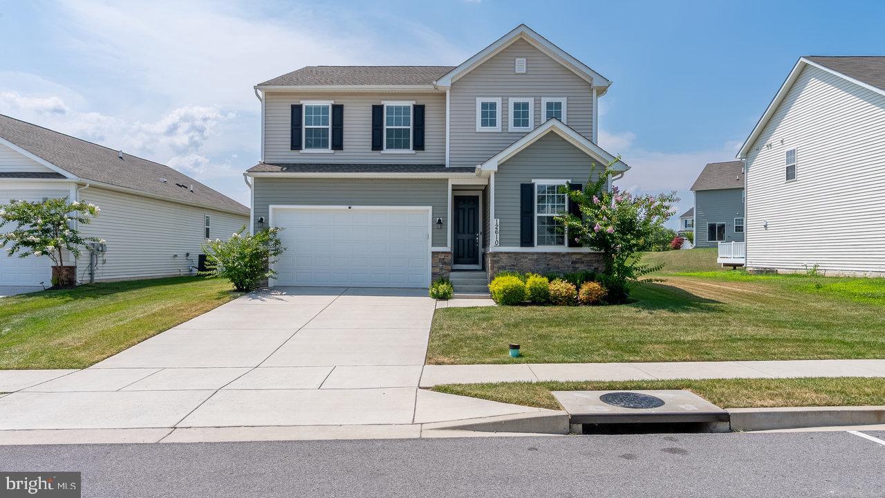 Discover this exceptional Executive Home in the desirable Hagers Crossing subdivision, built in 2020 and meticulously maintained in excellent condition. The home offers a spacious 2,453 sq. ft. of living space, perfect for customization to suit your lifestyle. Enjoy the convenience of an attached front-entry garage with space for two vehicles, complemented by a driveway that accommodates additional parking for guests. Inside, the home boasts a cozy electric fireplace, ideal for creating a warm ambiance during cooler months. The full unfinished basement presents a blank canvas, offering potential for additional rooms or a recreational area, with rough plumbing already in place for future bathroom installation. Community amenities enhance the living experience, including a in-ground swimming pool and tot lots/playgrounds for leisure and recreation. The association fee covers common area maintenance, road upkeep, and snow removal, ensuring a well-kept environment year-round. Outdoor living is enhanced with covered patio, perfect for entertaining or relaxing. This property is not just a home; it's a lifestyle choice in a vibrant community. Don't miss the opportunity to make this your own!