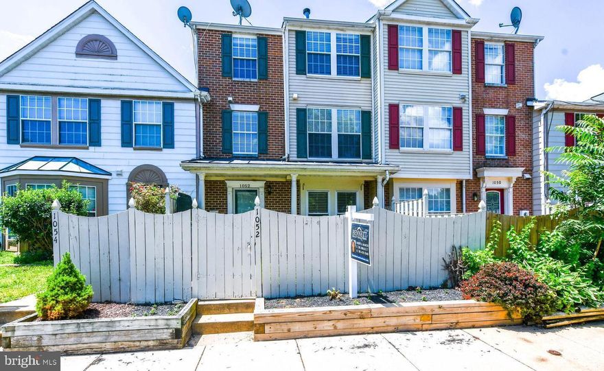 Welcome to your beautiful future home, this three-level townhome conveniently located within the Frederick City limits. Hardwood floors throughout the first and second level and brand new carpet in all bedrooms. Kitchen has been updated with Stainless steel appliances, granite countertops and farmhouse style bathroom vanities. All bathrooms have been updated with new vanities and fixtures as of 2022. The second floor features two, generously sized bedrooms, a full laundry room with washer and dryer for living level convenience, and a shared full bathroom with updated vanity, fixtures and lighting. Continue to the third level where you will find the grand primary suite with a wood burning fireplace! Appointed with an en-suite bathroom and ample walk-in closet space. This unit has two assigned parking spots (1052), an enclosed front yard with front porch for private enjoyment. This home is situated conveniently with easy highway access to 270, shopping and local amenities, and a short drive to downtown Frederick.