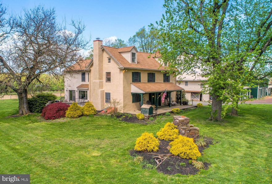 This classic Bucks County farmhouse estate offers a rare opportunity to own a fully equipped equestrian property set on nearly 13 picturesque acres in Hilltown Township. Designed with the serious horse enthusiast in mind, the property seamlessly combines a turnkey training facility with the timeless charm of a circa-1780 farmhouse—creating an ideal setting for both horse and rider.
At the heart of the farm is a 60' x 120' indoor riding arena, thoughtfully updated with masonry sand and fiber footing for optimal performance. Complementing the indoor is a 100' x 200' outdoor arena with well-draining footing, providing year-round versatility for training and riding. The well-appointed barn features 23 horse stalls, 4 pony stalls, and a two-stall shed row, along with two tack rooms, a kitchenette, and a bathroom for convenience. Eleven fenced pastures with solar-powered electric fencing allow for efficient rotation and turnout, while a round pen and hot walker support a complete training program. A private trail encircles the pastures, offering the ease of riding directly on your own property.
Above the barn, two beautifully updated apartments—one one-bedroom and one two-bedroom—provide excellent options for staff housing, guest accommodations, or rental income. One includes an enclosed porch, while the other offers a flexible bonus room.
The farmhouse itself overlooks the grounds, offering peaceful views of the pastures and daily horse activity. A welcoming wraparound front porch sets the tone, while inside, the home blends historic character with modern comfort. Wide-plank yellow pine floors, deep window sills, and exposed beams reflect its heritage, while the thoughtfully designed layout supports today’s lifestyle.
The living room features a striking stone fireplace with wood insert, and the dining room includes a built-in mirrored serving cabinet and generous storage. A dramatic floor-to-ceiling stone wall anchors the kitchen, which is equipped with cherry cabinetry, granite countertops, stainless steel appliances, and a bright breakfast area.
The family room, with its raised-hearth stone fireplace, opens to a private 530-square-foot two-tiered deck—perfect for relaxing or entertaining while overlooking the pastures. A mudroom with laundry, located on the barn side of the home, provides a practical transition from stable to house.
Upstairs, the primary suite offers a walk-in closet and a spacious bath with dual vanities, Jacuzzi tub, and separate shower. Three additional bedrooms and a full bath complete the second floor, while a walk-up attic offers expansion potential.
Additional highlights include a new roof (May 2024), updated HVAC systems (2022/2023), a newer oil tank and heater flue, and an electronic dog fence encompassing approximately six acres.
Beyond equestrian use, the indoor arena can easily accommodate storage for equipment, vehicles, or recreational boats. An adjacent equipment shed and a heated/cooled 1.5-car garage with 220 three-phase electric, high ceilings, and bright LED lighting make this property equally appealing for hobbyists or small business use.
Ideally located in the heart of Bucks County—just 5 miles from Dublin, approximately 18 miles from the Bucks County Horse Park, 35 miles from Philadelphia, and 80 miles from New York City—this property offers the perfect balance of accessibility and a private country setting.
Act 319 preferential assessment, which may allow for a one-acre subdivision, offering potential for a second homesite (buyer to verify). 24-hour notice required.