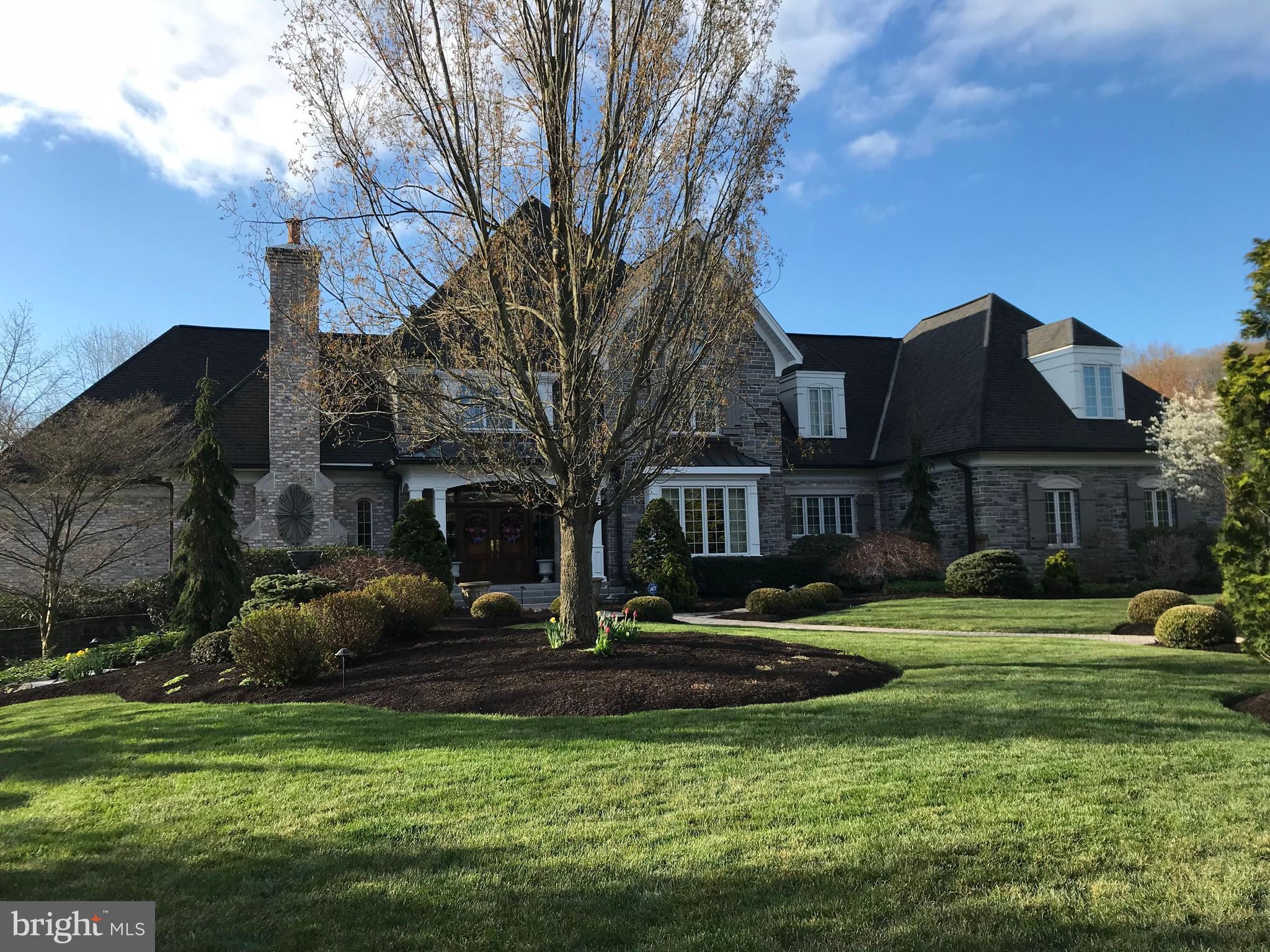 Come and appreciate the luxurious sophistication of this elegantly appointed home in the desirable community of Pinehurst. You will find over 6,400 square feet of exquisitely designed space that will seamlessly accommodate family and friends alike. A delightful blend of classic French country charm, modern amenities and incredible curb appeal, this home features 4 spacious bedrooms and 4 full and 4 half bathrooms. The exterior is beautifully done in stone and dryvit, with stunning landscaping and extensive hardscapes which include stately stone gate pillars, unique lighting, fountains and a hand-crafted brick driveway. As you enter this beautiful home, you will be greeted with a stunning curved staircase to the 2nd floor and will note the gleaming hardwood flooring plus all of the impressive and unique ceiling finishes, huge windows and the abundance of natural sunlight that floods each room with comfort and warmth. A gourmet kitchen featuring upgraded appliances and countertops, beautiful custom-made white cabinetry and a large butler's pantry will make meal preparation a joy - a chef's dream come true. There is a convenient 2nd staircase to the upper level of the home from the kitchen area and an adjoining laundry room with a laundry chute. A beautiful door with stunning stained-glass inserts provides a well-placed entrance from the driveway directly into the kitchen area for easy access with groceries, etc. The formal dining room also features a stunning ceiling and is spacious enough for hosting your large Holiday gatherings as well as more intimate family celebrations and boasts a unique closet for storing all of your table linens. Rounding out the first floor is an distinctive library with built-in shelving and a rolling library ladder, a family room with an adjacent 1/2 bath and access to the covered patio, a sumptuous Great Room with a vaulted/coffered ceiling and stone fireplace that serves as the heart of the home - creating a warm, cozy and inviting atmosphere for relaxing and recharging - and the luxurious Master Suite with another stunning ceiling, lovely en-suite bathroom and a truly generous walk-in closet. Upstairs you will find 3 additional bedrooms - each with its own full bath - all very spacious and masterfully designed to provide ample space for relaxation and privacy and a bonus room with an adjacent 1/2 bath that can flex with your individual needs (play room, office, gym - the possibilities are endless). There is generous storage space in the lower level to ensure that all of your belongings are easily organized and accessible along with a workshop and several separate spaces/rooms that can serve as storage/craft area/play area, etc. The very high ceilings and amazing spaciousness in the lower level could be easily finished for additional living space. There is also a 1/2 bath, a deep sink and a convenient garage door to the outside. Step outside onto the expansive covered patio with impressive pergola surrounded by the beauty of this wooded lot which is truly an outdoor oasis. This is the perfect setting for your morning coffee or evening barbeques - allowing you to immerse yourself in the tranquility of your private retreat. Don't miss the opportunity to experience the unparalleled comfort and style of this custom home.