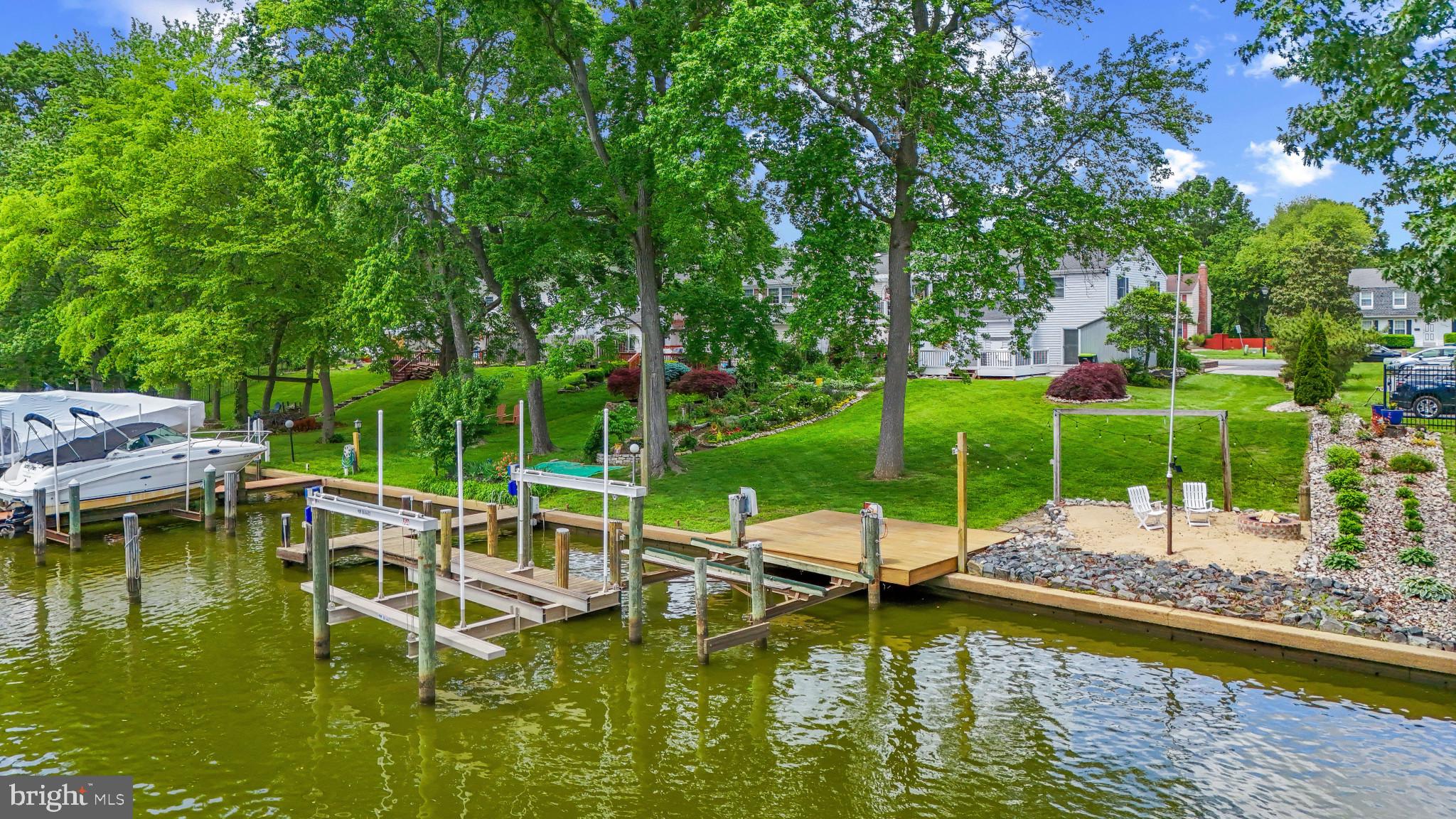 The Waterfront Opportunity that you have been waiting for! THIS OVERSIZED LOT HAS EVERYTHING!
Pier Ready to Dock Your 3 Boats --2 Boat Lifts( 1 Being a Hi-Tide with 20k lb. capacity )-- Private Beach w/Fire Pit to Enjoy the Views after a Day on the Water -- Bonus Waters Edge Sun Deck --Electric/Lighting runs Throughout Property-- Plush Sod throughout Backyard w/Mature Trees for Shade -- Paver Side Patio Lines the Meticulous Landscaping --5 Personal Parking Spaces and Plenty of Street Parking for those Large Gatherings --Oversized Storage Shed w/Electric --2 Level Large Private Deck Sets just off the Kitchen Slider doors, Perfect for Entertaining through the Seasons.
INSIDE ---Natural Light Pours Into Every Room through the Windows that Surround this 3 Bedroom Fully Renovated Home.-- Newly Updated Eat In Kitchen w/Granite Counters and Breakfast Bar--Large Family Room to Enjoy Year Round --New Flooring Throughout --Master Bedroom Boosts an Attached Updated Full Bath -- 2nd Full Bath Upstairs Updated as Well --Bedroom #2 & #3 can be converted to quiet Workspaces/Offices --Attic Space w/Easy Access Pulldown and more.....
Plenty of Room To Expand if ever Needed with this End Unit. Don't Miss Your Chance at This Unique Opportunity to Live on the Water at this Convenient Location to Popular Land & Waterfront Dining/Destinations---> SCHEDULE ONLINE TODAY !