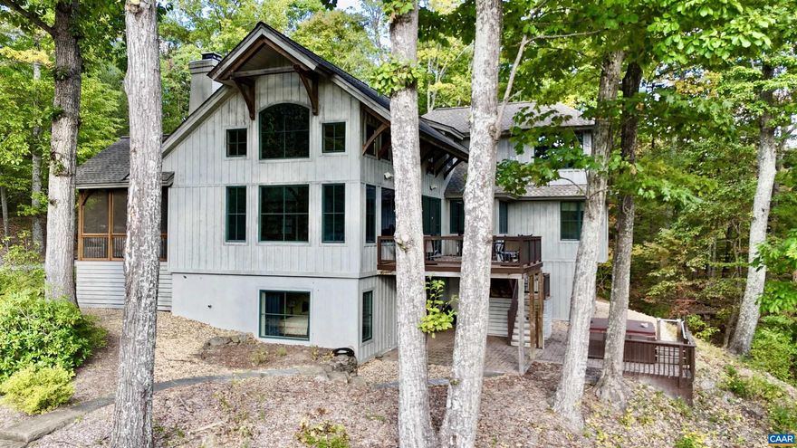The Point   A remarkable post & beam home perched on a scenic knoll above 250 feet of frontage on the Moormans River. Enjoy the mountain views from this private retreat near the Sugar Hollow Reservoir and the Shenandoah National Park. This custom-designed home was constructed by Smith & Robertson, Inc. The great room boasts a beautiful 22-foot timber frame cathedral ceiling with stone fireplace with raised hearth, and a wall of windows, taking full advantage of the expansive Blue Ridge Mountain views. An elevator services three levels of living, complemented by extraordinary outdoor living spaces; screened porch, decking and patios. The board & batten exterior with architectural dimensional shingles blends harmoniously with the canopy of mature hardwoods. The property features a large two-car garage with stairs to unfinished space above. There is a pool and hot tub with outdoor shower, fenced raised garden beds and potting tables, all enhanced by the professional landscape design by Bill Mauzy of Three Ridges Landscape Architecture. This property is truly a work of art with a setting that won't disappoint. House generator, central vacuum system, custom lighting and sculptured water fountain are a few of the fine features.,Glass Front Cabinets,Granite Counter,Solid Surface Counter,Fireplace in Living Room,Fireplace in Study/Library