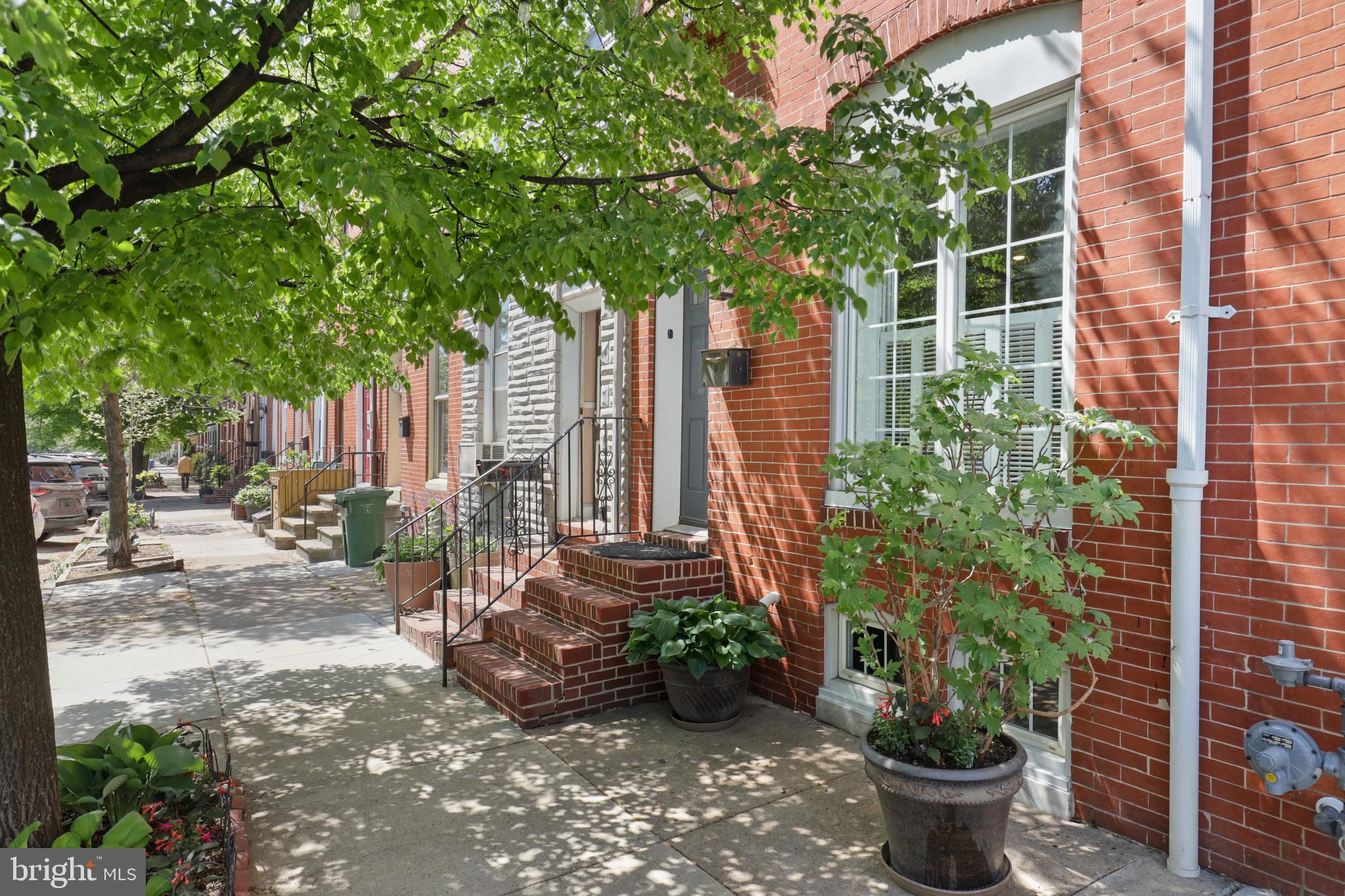 EXPANSIVE 3 STORY UPPER FELLS POINT HOME OFFERING A SEAMLESS BLEND OF HISTORICAL DETAILS AND MODERN AMENITIES. Located on quiet tree lined street in the Historic Upper Fells Point neighborhood, this stunning home features an open floor plan with gleaming original wide-plank pine floors, full-length exposed brick, crown molding, and decorative original fireplace in a spacious living room that flows into a separate dining room, gourmet kitchen, laundry/mud room, pantry, and main level full bath. Kitchen boasts gleaming stainless steel appliances and backsplash, granite and butcher block countertops, hardwood floating shelves, and generous storage in charming cabinetry. The 2nd level includes 2 large bedrooms with copious natural light, built-in shelving, multiple closets, and a full bath. The 3rd floor is an enormous master suite, with high ceilings, a walk-in closet, and a full ensuite bathroom. Unfinished basement can be used as a large storage space and is easily converted into an additional home office, exercise space, playroom, or work area. Enjoy the amazing enclosed rear courtyard on a generous deep lot as an outdoor entertaining area, with a recently-updated deck and patio space as well as space for gardening and for pets to roam! Walking distance to Johns Hopkins Hospital, Patterson Park, and the Fells Point waterfront, with multiple trendy restaurants, cocktail bars, breweries, and shopping all within a short walk.
