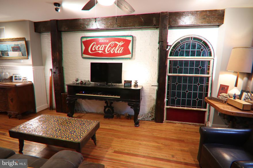 1,800 sq ft Locust Point Rowhome, WITH OFF STREET PARKING, Semi Furnished home available for rent, 11-20-25 for a 9 month to a year lease. Located in the sought-after LOCUST POINT neighborhood. 1223 Haubert Street is a beautifully updated rowhome with unique artistic details and accents with modern comforts. This 14' wide home offers two nice size bedrooms and closets and 2 full baths that combine to make one amazing bathroom with a skylight/rainspout, shower-head accessories and 4' copper barn and pocket doors! This home is highlighted by antique hardwood floors throughout, exposed brick walls and an airy, open-concept living and kitchen/dining/living area. Partially finished basement for entertaining. The kitchen features stainless steel appliances and a gas chambers stove. A park is located directly out the front door, perfect for your pet. Just moments from Fort McHenry, I-95, scenic waterfront paths, the water taxi, and a vibrant mix of local shops and restaurant. 
This home combines peaceful street-side living with easy access to commuter routes and city amenities... a true Locust Point gem. 
(new pictures to be updated soon)