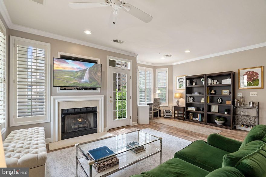 2 bedroom and 2 full bath corner unit with tons of light.  Open floor plan with kitchen, living, dining, and area for an office or utility area.  Large living space with 9' ceilings, walls of windows, and a gas fireplace.  Wrap around deck with beautiful views and seating area.  Master suite has a soaking tub and walk in closet.  Rarely available 2 secure garage parking spots in prime locations.  HVAC 5 years old, laminate flooring throughout done in 2018, stainless steel appliances and granite in kitchen.  Walk to everything - just a couple blocks to the metro, restaurants, and shopping.  The clubhouse is currently being renovated to include redone pool, a new exercise room, event room, bathrooms with shower, and new landscaping.  Condo fee includes water, sewer, trash, pool, club house, fitness center and common area maintenance.  Quick access to Rt. 50, Lee Hwy, I-66, Washington Blvd, Reagan National Airport, Pentagon and Crystal City, and DC.