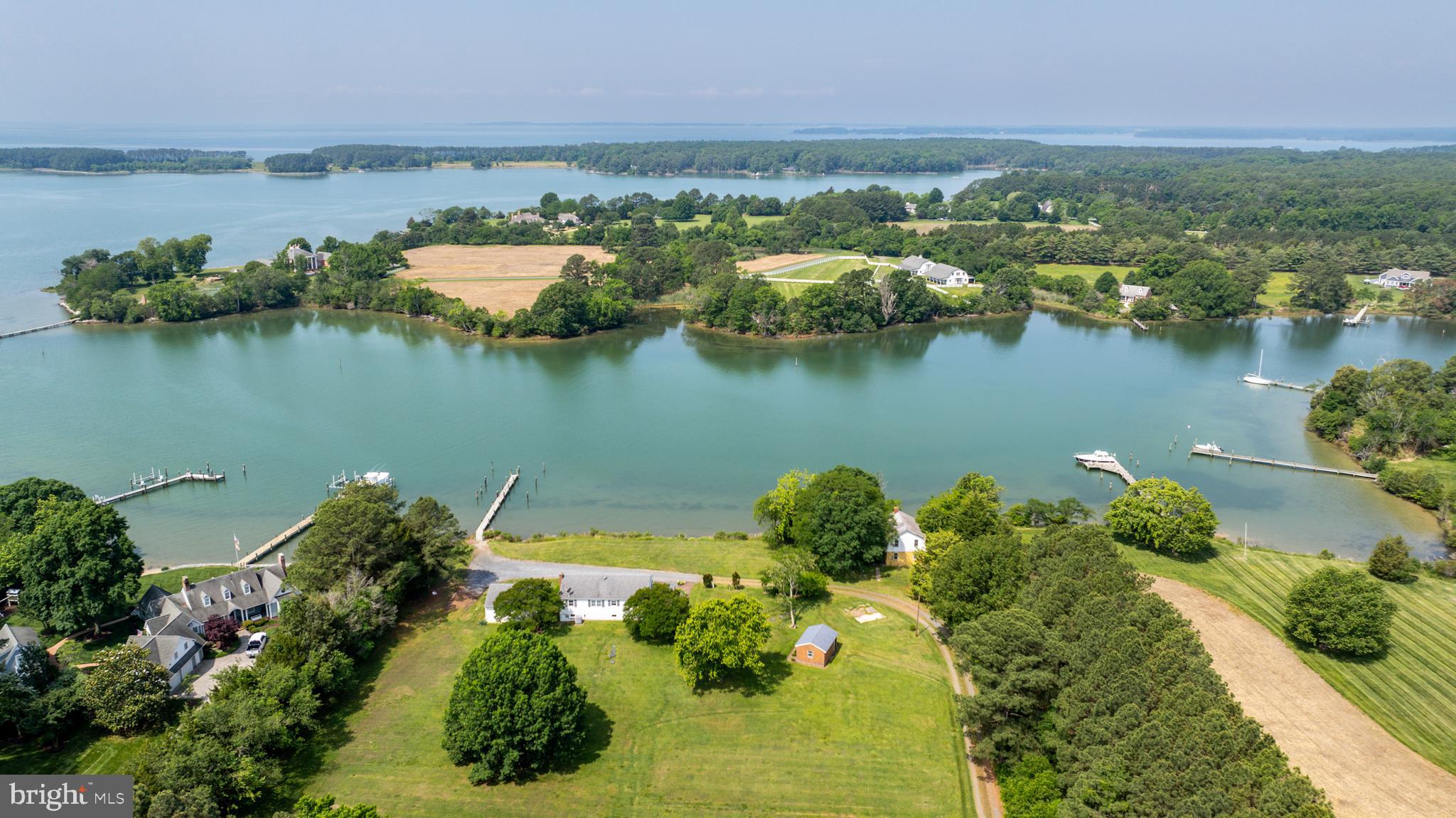 Nestled on scenic Haskins Cove with direct access to Irish Creek and beyond, this charming 3-bedroom, 1-bath split-level home offers private waterfront living. Featuring gleaming hardwood floors on the main level, the home opens to an elevated deck with sweeping views of the tranquil water—ideal for relaxing or entertaining. A private pier provides easy access for boating, fishing, or simply enjoying the serene surroundings. The property also includes a spacious two-car detached garage, offering plenty of storage for vehicles and outdoor gear. This is a rare opportunity to own a slice of waterfront paradise.