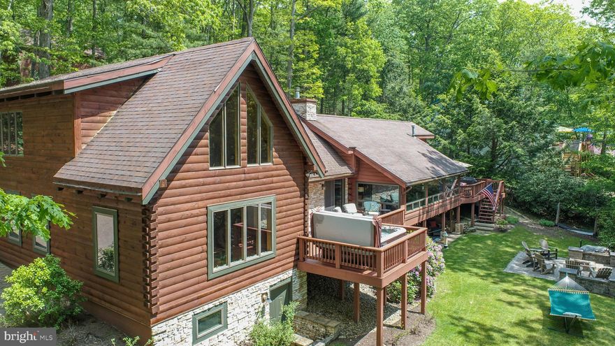 Lakefront Log Lodge Retreat on Deep Creek Lake!

Discover the perfect blend of rustic charm and modern luxury in this spectacular 6-bedroom, 4-bathroom lakefront log home, completely renovated in 2018. Situated on a private, oversized 1.2-acre lot, this lodge-style retreat offers 125 feet of prime deep-water frontage on Deep Creek Lake, complete with a private Type A dock, shoreline erosion control, and thoughtful lakeside landscaping already in place including a serene lakeside sitting area near the dock.

Inside the main home, enjoy a warm and inviting atmosphere with exposed log beams, a vintage stone fireplace with wood-burning insert, and a stunning sunroom showcasing panoramic lake views through a wall of windows. The gourmet kitchen features stainless steel appliances and high-end finishes, while the luxurious main level primary suite includes a beautifully tiled shower in the private bath. Step outside to enjoy the recently stained decks and a hot tub ideal for year-round relaxation, or walk out into the yard to enjoy the large stone patio with a lakeside fire pit. 

A paved driveway leads to the main house - and the separate, fully equipped 2-bedroom, 1-bath carriage house over a detached 2-car garage is perfect for guests. Additional features in the main house include central a/c and a whole house generator.

This private lakefront retreat delivers the ultimate Deep Creek Lake lifestyle!