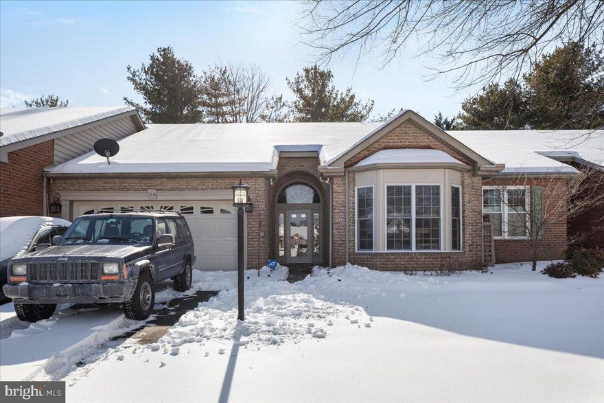 Welcome to this charming ground-floor villa offering comfort, efficiency, and peace of mind in over 1,400 square feet of thoughtfully designed living space, all within the quiet, well-maintained community of Spring Mills in Falling Waters. This single-level, move-in-ready home combines easy living with exceptional convenience to shopping, dining, and major commuter routes.

Step inside this timeless all-brick, two-bedroom, two-bath villa, where high ceilings and quality finishes create an open and upscale feel. The welcoming living area offers generous space for everyday living and entertaining and flows seamlessly into the modern kitchen, featuring granite countertops, stainless steel appliances, abundant cabinetry, and ample workspace, all adjoining the dining area.

Whether entertaining guests or enjoying a quiet moment, step out to the screened lanai—a peaceful retreat perfect for morning coffee or evening relaxation. Located just steps from the community pool and playground, the home enjoys the rare benefit of close proximity while remaining buffered by mature pine trees that provide privacy along with sound and light shielding.

The spacious primary suite offers a large walk-in closet and an updated en-suite bath, providing comfort and style. Additional recent updates include new floating floors throughout the dining area, front office/bedroom, hallway, laundry area, and both bathrooms. Hard-wired smoke and carbon monoxide detectors add an extra layer of safety and peace of mind.

The surprisingly spacious garage accommodates multiple vehicles plus equipment and is complemented by pull-down attic stairs for additional storage, along with a dry crawlspace with lighting—maximizing usable space throughout the home.

Recent updates include:
• 2025: New 50-gallon water heater
• 2023: New vanity and paint in primary bath, upgraded toilet in second bath, new kitchen microwave and garbage disposal
• 2021: New water softener and radon mitigation system

Residents of Spring Mills enjoy outstanding community amenities, including walking trails, a large pool, tennis, basketball and pickleball courts, playgrounds, and a clubhouse. The location offers quick access to I-81, Route 11, and the MARC train in Martinsburg, making commuting to Maryland, Northern Virginia, or Washington, D.C. convenient and efficient.

This beautifully maintained villa offers the perfect blend of single-floor living, modern updates, and an exceptional location—ready for you to move right in and enjoy.