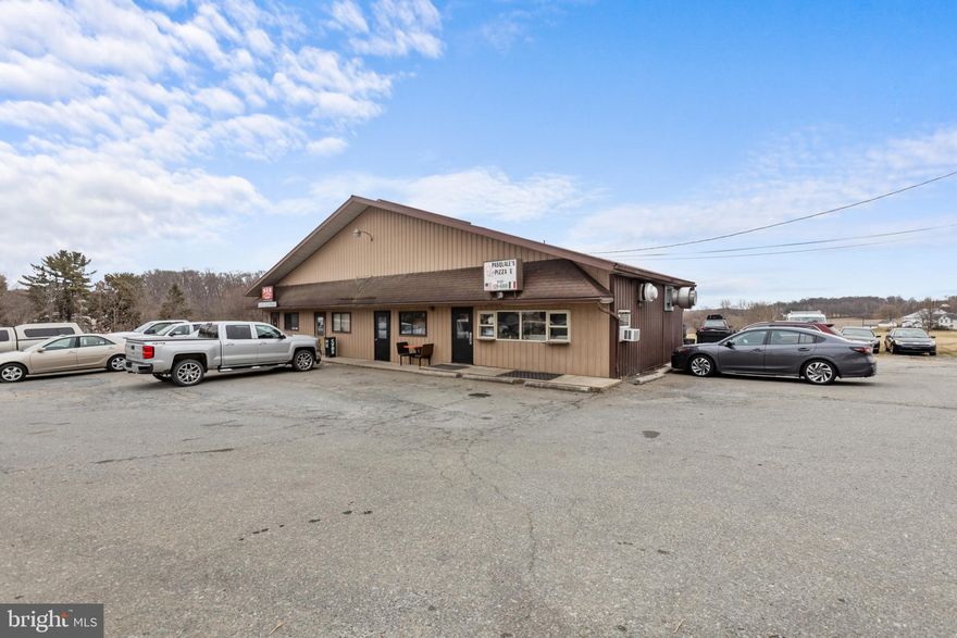 Welcome to 399 Nottingham Road in Nottingham, PA! The property is currently occupied by two long term tenants, an auto mechanic and a pizza shop. The auto shop is about 2,669 SF and consists of a small office space and a 45 x 41 shop with two overhead drive-in doors. The Pizza shop is about 1,400 SF and has a kitchen with a cashier counter, a small dining area with six tables, and a storage room. The property is separately metered so tenants pay their own utilities and share two common area restrooms. The businesses benefit from high visibility on a 0.31 acre corner lot at the busy intersection located at Nottingham Road and Brown Road in Lancaster County. This sale includes the real estate only, no businesses or trade fixtures included in the sale.