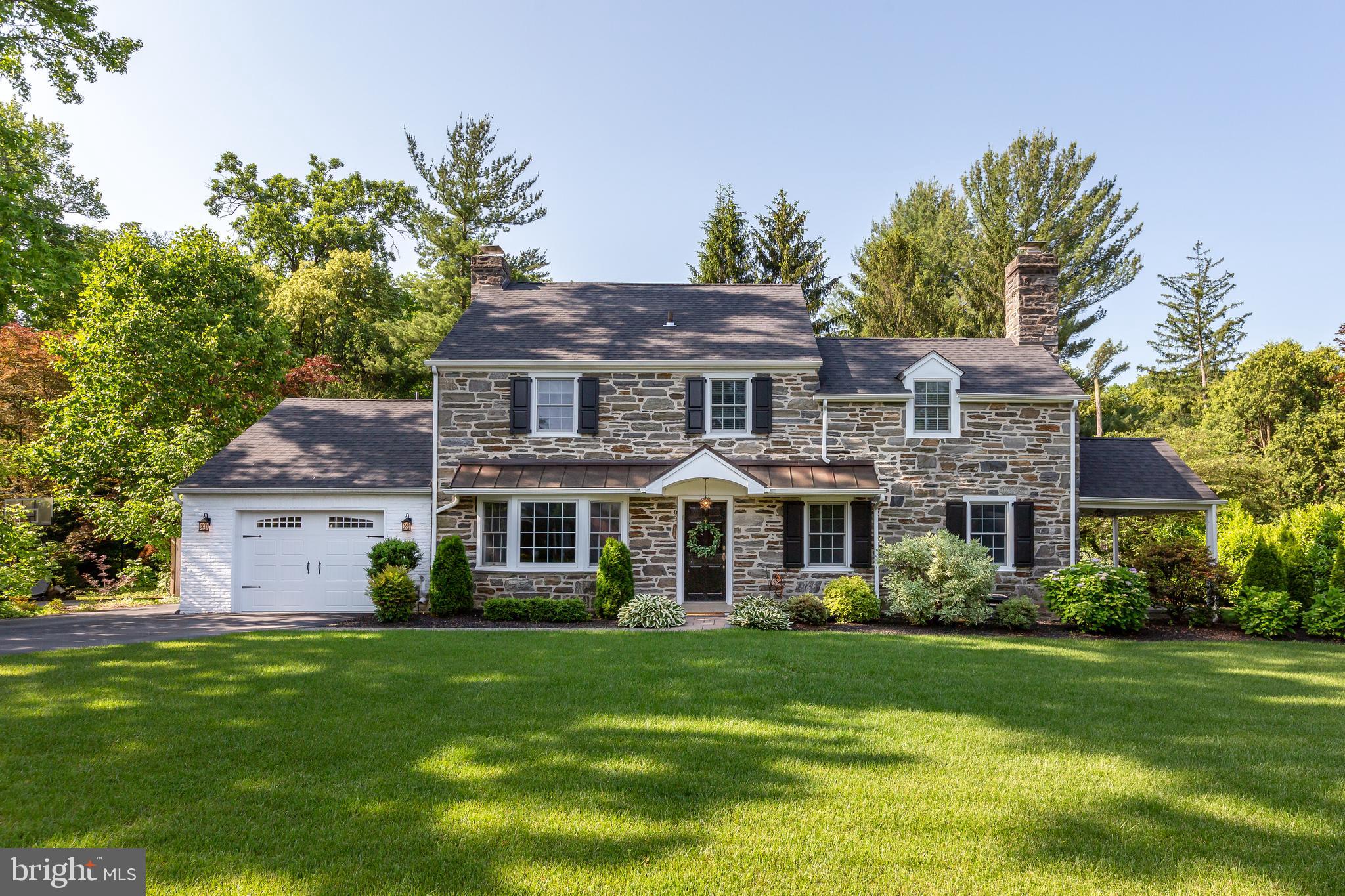 Welcome to 20 Aldwyn Lane, a charming and meticulously maintained 4-bedroom, 3.5-bath Colonial set in an unbeatable Main Line location—just steps from Villanova University. This home beautifully blends classic architectural details, like the stone-and-siding facade, deep-silled windows, and flagstone patio, with modern-day amenities including a home office, front-entry attached garage, and a showstopping, fully renovated kitchen. Located in the award-winning Radnor School District and convenient to both Villanova and Bryn Mawr, you’ll enjoy easy access to top-rated schools, scenic parks, boutique shopping, vibrant dining, and more.
Designed for both everyday comfort and effortless entertaining, the home welcomes you with a classic center-hall foyer that opens to spacious living and dining rooms, each featuring hardwood floors and elegant crown molding. The living room centers around a gas fireplace—perfect for cozy evenings—while the formal dining room is highlighted by a beautiful bay window overlooking the front lawn. At the heart of the home is the thoughtfully redesigned kitchen: expansive, sunlit, and outfitted with a large center island, walk-in pantry, and stainless steel appliances including double ovens and a beverage fridge. Just off the kitchen, a heated mudroom with built-in storage and a laundry closet provides practical everyday functionality and direct access to the attached garage. A stylishly renovated powder room and a window-lined home office looking out onto the backyard complete the main level.
Upstairs, you’ll find three generously sized bedrooms, including a luxurious primary suite featuring dual closets, custom built-ins, and a spa-inspired en suite bath. A full hallway bathroom serves the remaining two bedrooms. The third level is fully finished and offers a private guest suite with its own full bathroom and additional closet space—ideal for visitors or extended stays. The fully finished lower level adds even more versatile living space, with recessed lighting, built-in shelving, ample storage, and an elegant tray ceiling detail. Step outside from the kitchen to the covered porch and flagstone patio—an inviting outdoor retreat perfect for morning coffee or summer entertaining.
Tucked away on one of Villanova’s most picturesque tree-lined streets, Aldwyn Lane is beloved for its curb appeal and community feel. A pedestrian bridge at the end of the street provides direct access to Villanova’s campus, while nearby transit options—including the Regional Rail and Norristown High Speed Line—and major routes like I-476, I-76, and Lancaster Avenue make commuting a breeze. Come experience the best of Main Line living at 20 Aldwyn Lane—where timeless charm meets modern convenience in an unbeatable location.