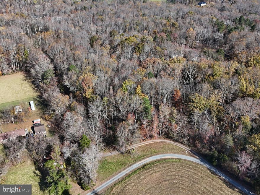 KING GEORGE ACREAGE: Wooded 8.6 Acre parcel with private road access off of Weedonville Dr.  Some partially cleared areas with a small stream at back of property.  Soil evaluation letter and survey are available.  The property is just minutes from Dahlgren, schools, shopping and amenities.