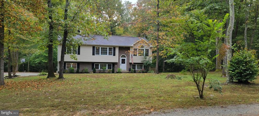 Price reduction!!  Looking for space in your home, and around your home?  Come and see this fabulous split foyer with over 2500 SF sitting on 4.6 acres with a nice "park like" setting.   (Tax record doesn't reflect actual finished square footage).  This home has 4 amply sized bedrooms, 3 full baths, an open concept kitchen/family room with unique custom hard wood flooring on the main level (carpeted bedrooms).  The master bedroom has a vaulted ceiling, and a walk-in closet you'll appreciate!  The lower level could be an in-law suite, or a great space for your teenager to live with a spacious rec room, bedroom, and full bath.  There's still space for your seasonal items in the storage room!  If you enjoy being outdoors, there's a large deck on the upper level, and a deck on the lower level that's pre-wired for a hot tub.  Enjoy gatherings with family or friends under the pavilion with space to accommodate large groups of people.  This home has so much to offer!