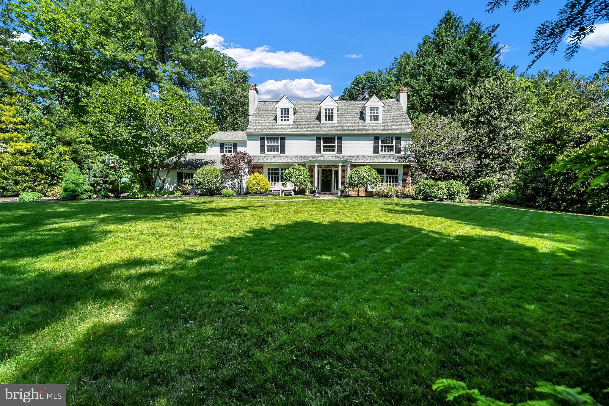 Wayne's Perfect Blend: Comfort, Privacy, and Location.
Immerse yourself in comfort and luxury in this stunning 5-bedroom, 4.5-bathroom custom colonial estate, nestled on an acre of land in sought-after Wayne, PA. Perfect for entertaining, the expansive first floor boasts a semi-open floor plan, featuring a chef's dream kitchen redesigned by Joe Chicco in 2014. The kitchen showcases a large island with built-in storage, a breakfast area with breathtaking views of the backyard, and an elegant cathedral ceiling, all accompanied by heated floors. Create a warm and inviting atmosphere for friends with two cozy dens and a large formal dining room, each featuring its own wood-burning fireplace. Upstairs, a light-filled haven awaits. The great room features a vaulted ceiling and a dramatic atrium window overlooking the meticulously landscaped backyard and the two-tiered brick and stone patio, ideal for hosting memorable gatherings. The luxurious main bedroom is complete with cathedral ceilings, a walk-through closet leading to a private bathroom, and wonderful views. Two additional bedrooms, one with an ensuite, and a hallway bathroom complete the second floor. A versatile third floor offers a bathroom and two more bedrooms, with the option to convert one into a perfect home office. This space is perfect for teenagers, guests, or a dedicated creative space.
This exceptional property is located in historic Wayne, PA, placing you in the heart of the charming Main Line. Enjoy the convenience of being in close proximity of everything you need: churches, preschools, the Mill Dam Swim Club, Wayne Elementary School, a network of paved and unpaved walking trails, and the Wayne Art Center. Step outside to your private backyard oasis surrounded by a wooded backdrop, perfect for outdoor parties or relaxing under the stars. Across the street is Dittmar Park, a verdant escape just a few steps away, offering a serene natural environment to relax and connect with nature. This custom-built home offers the perfect blend of comfort, privacy, and an abundance of natural light. Create lasting memories in this inviting space. Listing Agent is related to seller.