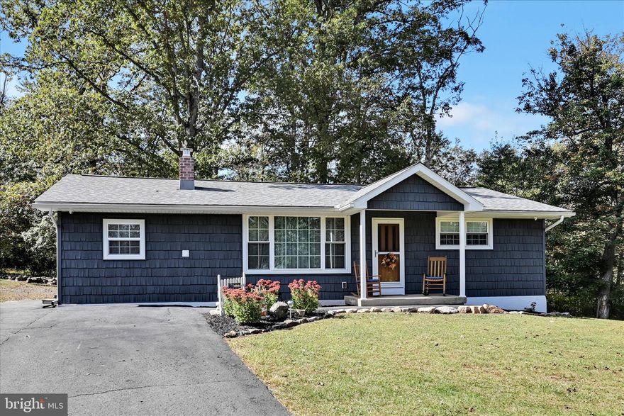 Beautifully remodeled ranch home offering comfortable one-floor living in a peaceful, gated mountain community surrounded by wooded scenery and freshwater lakes. Situated on a rare, flat double lot, the home features two bedrooms and one bathroom, with all-new plumbing and electrical throughout. The kitchen showcases custom solid maple cabinets, handcrafted countertops, and stainless steel appliances, while quality waterproof luxury vinyl plank flooring runs throughout the living spaces. Major system upgrades include a high-efficiency heat pump, new propane backup heating, a tankless water heater, and a new 50-year roof, ensuring peace of mind and long-term value. Additional features include secondary heat in the basement, a second laundry hookup for added flexibility, and a large shed with electric, perfect for storage or a workshop. Located close to both Dock A and Dock B, as well as the main gate, this property combines privacy and convenience in a serene natural setting. Whether you're looking for a year-round residence, weekend getaway, or investment property, this move-in-ready home offers modern upgrades, functional design, and the tranquility of mountain living.