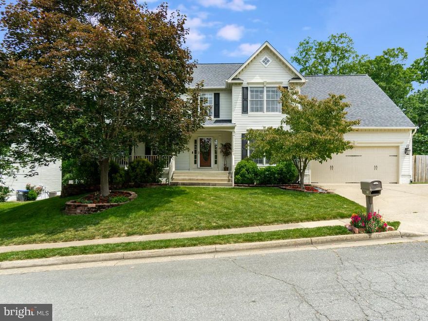 Move In Ready, 4BR, 3.5BA Colonial on Quiet Cul-De-Sac In Austin Ridge! Highlights and Features Include: Finished, Walkout Basement with Kitchenette, PERFECT For In-Law Suite!! Gleaming Hardwood Floors & Crown Molding Throughout Most of Main Level; Two Story and Cathedral Ceilings; Main Level Office w/Ceiling Fan & Light; Living Room w/NEW Ceiling Fan w/Light & Crown Molding; Dining Room w/NEW Chandelier, Crown Molding & Chair Rail; Kitchen w/Granite Counters & Breakfast Bar, Tile Backsplash, Stainless Steel Appliances including NEW LG Fridge & Gas Stove, Recessed Lighting, Conveying  Center Island & Granite Top Cabinet Plus Pantry; Breakfast Room w/Crown Molding & Sliding Glass Door To Rear Deck; Family Room off Kitchen w/Wood Floors, Cathedral Ceiling w/NEW LED Lights, Ceiling Fan w/Light & Gas Log Fireplace; Laundry Room off Oversized Two Car Garage w/Wood Flooring & Built In Shelving; Half Bath w/Vanity w/Storage and Hardwood Floors Complete The Main Level. The Upper Level Features 2nd Story Foyer Overlook; Primary Bedroom w/TWO Walk In Closets, Cathedral Ceiling, Carpet & Ceiling Fan w/Light; Attached Primary Bath w/Dual Sink Vanities w/Storage, Ceramic Tile Floors, Soaking Tub & Step In Shower w/Ceramic Tile Surround; Bedroom 2, 3, & 4 have Carpet, Double Door Closets, & Ceiling Fan w/Lights; Hall Full Bath 2 w/Tub/Shower &  2 Sink Vanity w/Storage  Complete the Upper Level. The Lower Level Features Bathroom 3 w/Vanity w/Storage & Tub/Shower; Gym/Den w/Double Entry French Doors & Built in Shelving; Large Rec Room w/2 Ceiling Fans w/Lights & FULL Kitchenette w/Gas Stove & Ceramic Tile Floors & Sliding Glass Door To Rear Patio; Not To Code Bedroom w/Carpet, Closet, & Ceiling Fan w/Light; Utility Room w/Laundry Hook Ups & Storage to Complete The Lower Level. Additional Highlights Include: Whole House Humidifier & Water Heater(2020); NEW Fully Privacy Fenced Rear Yard w/Beautifully Landscaped Walkway; UPDATED Rear Deck w/Stairs to Grade;  2 Car Garage w/NEW Storage Attic & Driveway w/Parking for 5.  Community Amenities Include: Tot Lots/Playgrounds, Jog/Walk Nature Path, Community Pools & Community Center! This Home is Located at End of Cul-De-Sac & Is Less Than 5 Miles To I-95, Quantico, Shopping, Commuter Lots & More!