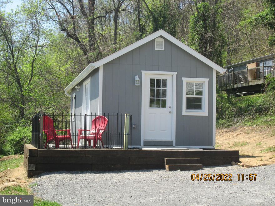 Tiny home overlooking the historic town of Berkeley Springs. This brand new compact efficiency home  is an affordable alternative to renting! Open floor plan offers a combination living room/ kitchen. The kitchen area features stainless appliances, including gas range. Plenty of cabinet space for storage.  Bedroom fits a full size bed and the 10 x 12 loft can accommodate a queen sized bed or it can be used as a storage area.  Perfect for starting out or starting over, or a weekend getaway. Just minutes from the town of Berkeley Springs where you can enjoy dining, shopping, antique shops , art galleries, or the spas and pool at Berkeley Springs State Park. Call today for your viewing of this unique property.