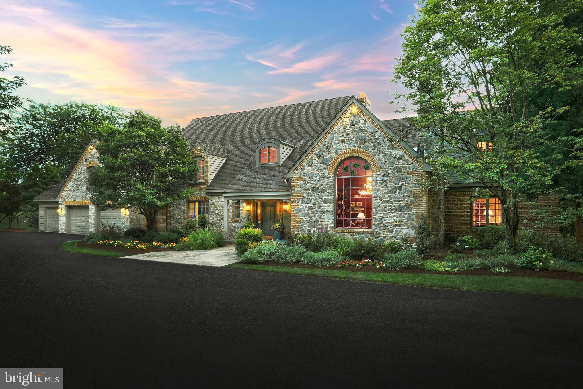 Located in Wyndham Hills this Custom Built lovely French Country Estate was built by Alan Deamer. The property is tucked away in a gated private driveway minutes from the York Country Club and easy access to all York has to offer on 1.42 Acres. The professional landscaping accents the richness of the stone and brick structure. Five Bedrooms, Five Full Baths plus Two Half Baths. You enter this beautiful home thru the Covered Front Porch into a two story grand staircase which is open to the balcony above with inlayed oak flooring . The Family Room has finished on site wide plank oak wood flooring, crown molding, cathedral ceiling, built-ins, atrium French doors that open to the a large patio. An open contemporary look to the Gas Fireplace adds character and charm surrounded with built-in bookshelves and cabinets to show off your many treasurers. Enjoy the Formal Dining Room with Cathedral Ceiling and Atrium Windows, plus Wood Floors that are open to the Family Room and Kitchen with breakfast area. This is perfect for family gatherings and entertaining friends. Make yourself at home in this Gourmet Kitchen with oversized Cherry Wood Island with overhang for seating and built-in vegetable sink. Any Cook would love the Wolf Commercial Gas Range/Oven, Sub-zero Refrigerator/Freezer, Stainless Steel Dishwasher, Granite Sink, and Pantry. Large Breakfast Area that overlooks large patio, with overhead Trellis and Hot Tub. Right off the Kitchen and Family Room is the Screened in Porch with Cathedral Ceiling picturesque overlooking the Salt Water In-ground Pool. The entire home is filled with character and charm and extra special features that quality Buyers would appreciate. Also on the 1st Floor is a Office/Sewing Room conveniently located close to the busiest working area of the house. Just off the Kitchen and Family Room. Built in Desk, Cabinets and Drawers, Walk-in additional pantry or to store additional supplies. This room comes a movable floating Desk and more built-in cabinets on the other side of the room. You can never have enough storage space. Just off this special room is the Laundry Room with Laundry Shut from Second Floor, Laundry Tub, hanging area for drying wet clothes, Washer/Dryer, plus built in cabinets. Off of the Foyer is a very special Library with Coffered Ceiling with Cherry Finished Cabinets, Shelving and Gas Fireplace with Burled Walnut above the mantel. Stunning Stained Glass Window, Built-in Window Seat, Carpet with Cherry Flooring and to finish off this special room hangs an Antlered Chandelier. First Floor Primary Bedroom on 1st Floor with Wood Flooring, Tray Ceiling, Gas Fireplace, Plantation Shudders, Walk-in His/Her Closet with built-ins dresser. Primary Bath has marble flooring, granite counter tops, custom shower, and Mr. Steam. There is an additional large bedroom on this level with it's own bath. A Three Car Oversized Garage rounds out the 1st Level. Upstairs features another Three Bedrooms with Two Full Baths. Every window has a great view. Downstairs has a large Recreation Room, Game Room and Exercise Room. Perfect Location for any Buyer! Don't wait to make this incredible home your next residence!