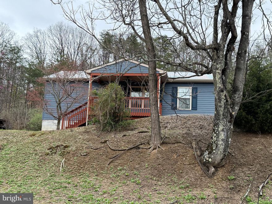 Charming Residence! Enjoy single-level living in this home, boasting 2 bedrooms, 1 bath, laundry closet, an eat-in kitchen with granite countertops, open to the living room.  A covered front porch for relaxation. Features include a heat pump/central air, public water and sewer. Situated on 1.35 acres.