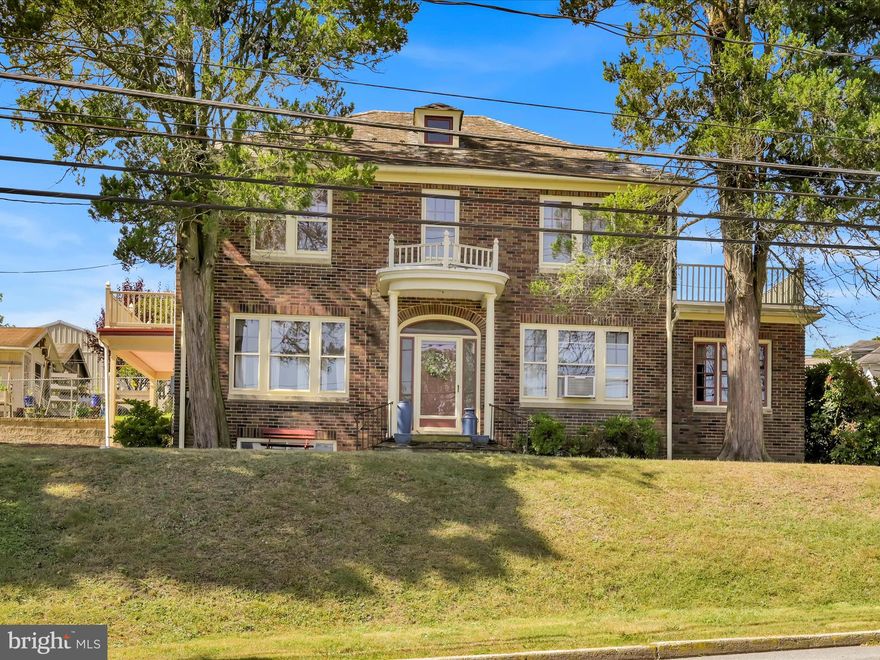 Discover the timeless elegance of this stunning 4BR/3BA Colonial home, perfectly positioned on a corner lot with breathtaking mountain views. This well-maintained brick exterior with recently painted trim showcases a gorgeous, well-maintained slate roof with 1-year craftsmanship warranty that adds authentic historic charm to the property's impressive curb appeal. Step through the grand entryway into thoughtfully designed living spaces that blend classic character with modern convenience. The main floor features a spacious kitchen complete with breakfast nook and pantry, complementing the living room, dining room, and beautiful enclosed heated sunroom - perfect for year-round enjoyment. The recently updated half bathroom adds practical functionality to daily living. Upstairs, 4 large bedrooms and a full bathroom provide comfortable accommodations for family and guests. Throughout the home, you'll appreciate the quality construction evident in hardwood flooring and solid wood doors that speak to lasting craftsmanship. Recent improvements enhance both comfort and efficiency, including a newer furnace (approximately three years old), updated 200-amp electrical system, new rubber roofs with vinyl railings surrounding each balcony, and fresh washer and dryer connections. All remaining appliances, window treatments, and two air conditioning units convey with the sale. The full unfinished basement coated with epoxy water sealer paint offers excellent potential for additional living space or storage. Outside, ample off-road parking with convenient alley access ensures easy vehicle management. Located just minutes from downtown shopping and groceries, this property offers small-town convenience with Saylor Park, Island Park Complex and quality schools nearby. This is practical living wrapped in historic beauty.
