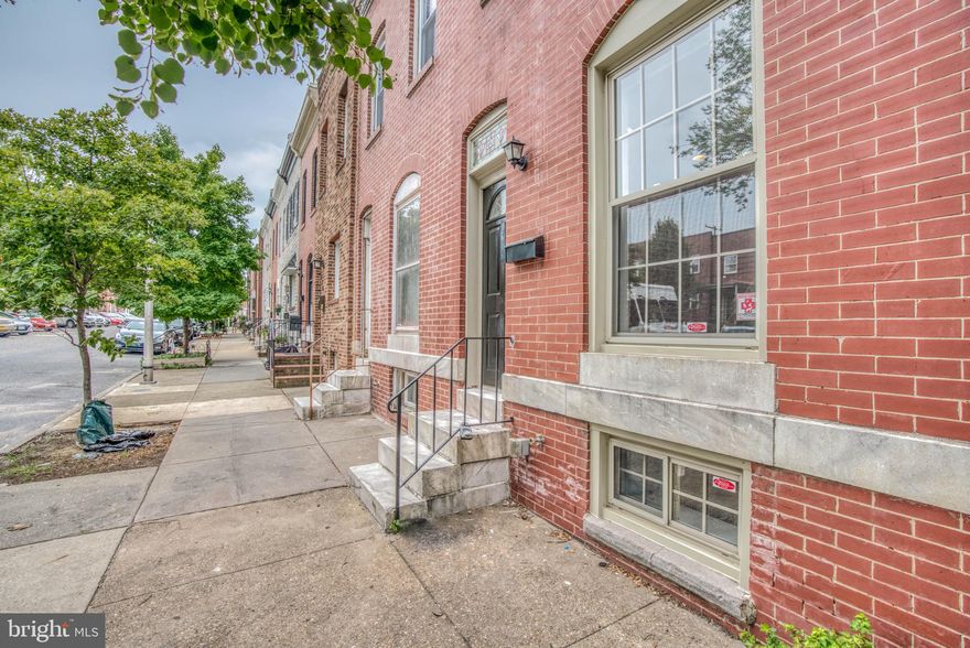 Renovated 2 Bedroom, 2.5 Bath Patterson Park townhouse with large parking pad. Finished basement offers potential 3rd bedroom. Tiled kitchen with wood cabinets, granite countertops, and stainless appliances. Open layout with exposed brick and hardwood floors. Upstairs features two bedrooms and two full bathrooms. Great location close to everything.