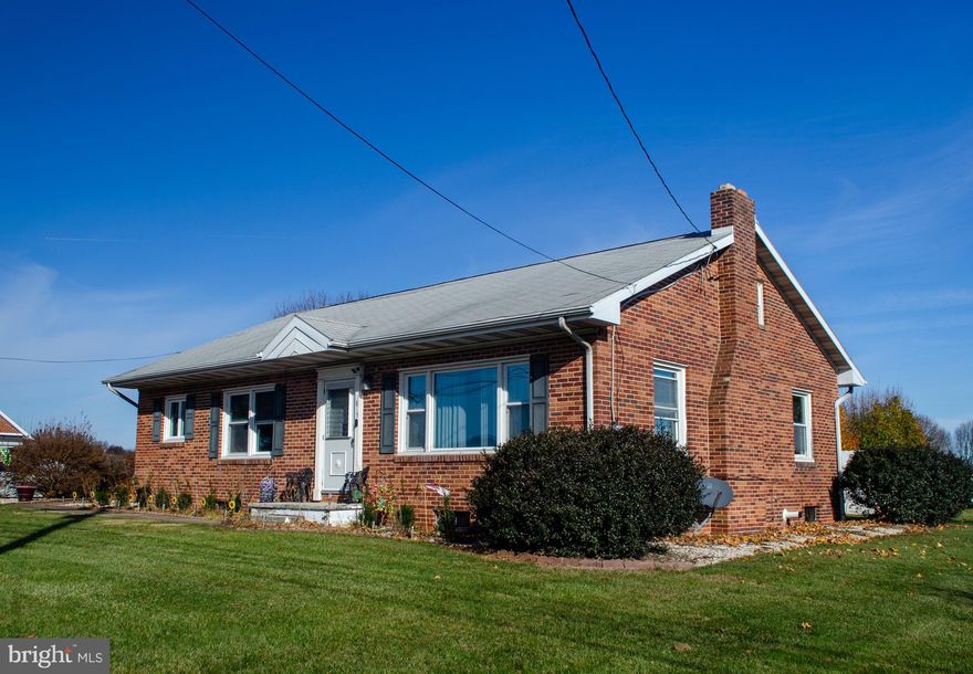 Solid brick-well taken care of ranch home with many updates located on a nice level lot backing up to farm fields. Home features original hardwood floors & additional possible living space in basement and in 2nd floor attic area. 3 recently painted bedrooms on main level alongside an updated bathroom. Modern kitchen with tile backslash.  300+ sq ft sunroom, 1/2 bath located in lower level. Tankless Hot Water Heater and Central Vac System.  2+ car attached garage and one heck of a nice 20x14 workshop, perfect for the shade tree mechanic of woodshop hobbyist.  Partially fenced rear yard. Schedule your showing now before this fine home is sold.