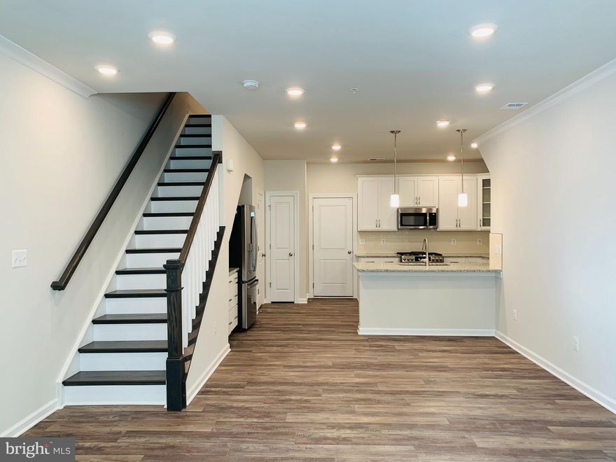 Within walking distance offering convenience & accessibility to much of the Washington DC w/ Ashburn Station METRO! Town Home style, cozy two-level, stacked condo; lower Condo w/1614 sq ft | Condo features an open layout w/great rm, dining rm & kitchen, w/access to the garage on the first floor. On the second floor is the luxe owner’s suite w/a private deck & two extra bedrooms | Attached 1 car rear garage w/opener | Beautiful luxury vinyl planks (LVP) flooring all thru first level | SS appliances | Granite counters | Walk-In-Closet in primary bedrm | Blinds | Washer & Dryer @ bedroom level | Minutes to Dulles Landing Shops | Close to Shopping, Medical, Library, Restaurants, and much more | Excellent access to Dulles Toll Road/Rt. 267, Route 7 and Route 28. Tysons Corner Center, Fair Oaks Mall, Dulles Technology Corridor, Dulles 28 Centre, Claude Moore Park, 1757 Golf Club, and Loudoun Station are all just minutes away | Excellence in style, function & location