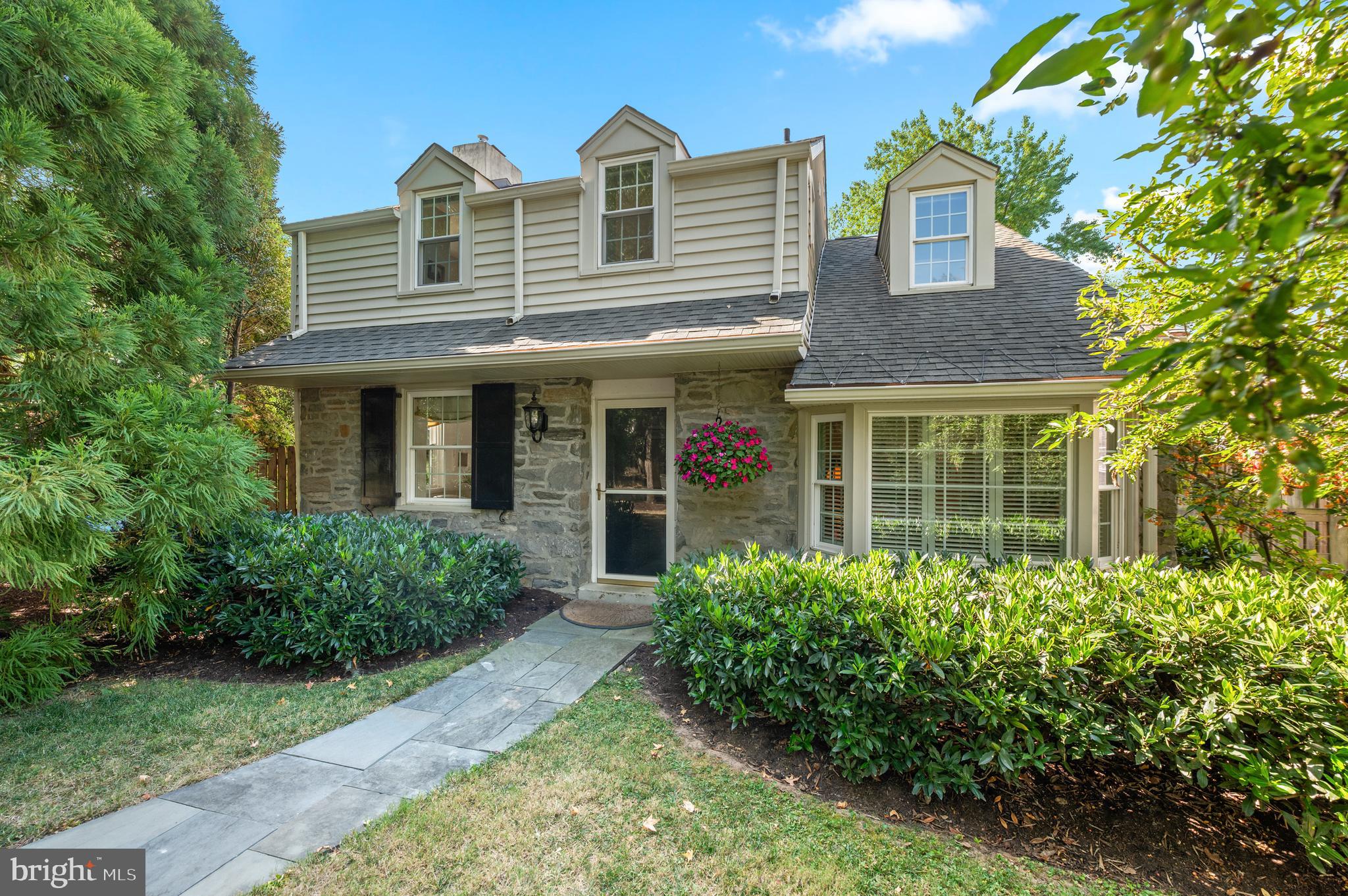 Situated in one of the Main Line’s most walkable neighborhoods, this beautifully maintained colonial offers exceptional curb appeal, thoughtful updates, and a true sense of community. Just a short stroll to the Strafford train station, the home is part of a vibrant enclave known for its 4th of July parades, school’s-out celebrations, and active residents’ association. Everyday conveniences and beloved Main Line destinations—Whole Foods, the new Berwyn Trader Joe’s, Strafford Farmers Market, Devon Horse Show, Terrain, and Anthropologie—are all close at hand. 28 Homestead makes a memorable first impression with its professionally landscaped gardens, Belgian block-lined driveway, and curving bluestone walkway. Side-by-side parking for two cars adds everyday ease. Southern exposure fills the home with natural light, while the fully fenced backyard offers privacy, mature plantings, and a wisteria-covered arbor providing natural beauty and shade. A sunny deck extends the living space outdoors, and the property offers room for an addition—many neighbors with this same style home have expanded, further enhancing its long-term potential. Inside, the main level features a welcoming living room with fireplace, a formal dining room, a thoughtfully renovated kitchen, and a bonus family room/den. The kitchen blends timeless design with modern function, offering Kountry Craft cabinetry, Silestone counters, cream subway tile backsplash, shelving with plate grooves, beadboard detailing, and a bar-height counter with additional storage. High-end appliances include a GE Café dual oven gas range, Bosch dishwasher, KitchenAid French door refrigerator, and Grohe faucet, all complemented by dimmable overhead and under-cabinet lighting. Upstairs, three bedrooms include a generous primary suite with its own bath, alongside a full hall bath with Grohe/Moen fixtures and Speakman shower heads. The finished, walk-out lower level adds approximately 360 square feet of flexible living space, along with storage rooms and a laundry closet. Mechanical and structural updates provide peace of mind: roof (2021, under warranty), hot water heater (2025), CertainTeed tilt-in windows, siding and insulation, HVAC with new chimney liner (2017, serviced biannually), radon system (2022), French drain and sump pump, surge-protected electrical panel, and biannual gutter cleaning. Additional features include a shed with loft storage and workbench (2019), motion-sensor backyard lighting. Meticulously cared for and thoughtfully upgraded, 28 Homestead offers warmth, flexibility, and the best of Wayne living—ready to welcome its next chapter.