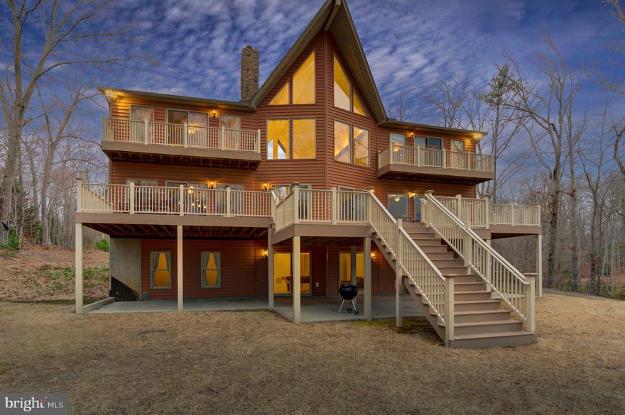 Welcome to the Lake House!  A stunning waterfront masterpiece, this custom built oasis offers a spectacular and rare opportunity set upon the beautiful shores of Lake Anna, Virginia on the public side of the lake.  Truly unrivaled in quality and design, this impeccably crafted escape blends modern luxury living with tranquil lake lifestyle.  Encompassing over 5,600+ finished square feet on three levels, this paradise offers lakeside living at its finest, with 6 bedrooms, 4.5 baths, TWO spacious primary en suites each their own private balcony overlooking the lake, a large two-tiered back deck constructed from composite decking also overlooking the water, giant 3+ car detached garage with storage above and over 170+ feet of private shoreline down at the water’s edge.  Step inside into a sunny open floor plan punctuated by very high ceilings, floor-to-ceiling windows that showcase gorgeous water views of Lake Anna, a double sided wood burning fireplace with gorgeous floor to ceiling stone and hardwood flooring throughout.  The gourmet kitchen supplies a 6 burner gas stove top with griddle, SS appliances and granite counters.  Downstairs in the walkout basement, you'll find 4 bedrooms, 2 full baths and a family/recreational room.  This home has an outdoor shower, advanced constant pressure water tank system and the oversized detached garage has a 220 AMP service.  A few steps away at the water, you’ll enjoy warm summer days down at your very own two-story boathouse (built 4 years ago) that has 2 electric lifts, 2 jet ski lifts, storage area and swim/sun deck.  DEEP CLEAN WATER (12-14ft at end of dock).  The perfect mid lake location just below the 208 Bridge and just minutes to local dining, marinas, groceries, Lake Anna Taphouse and many other breweries & wineries.  Nestled on 2.66 acres and NO HOA!  Furniture, Furnishings, Lawn Mower & Golf Cart can convey!  Short Term Rentals are Permitted.  See Rental Projection in MLS Documents.  Come see for yourself and fall in love!