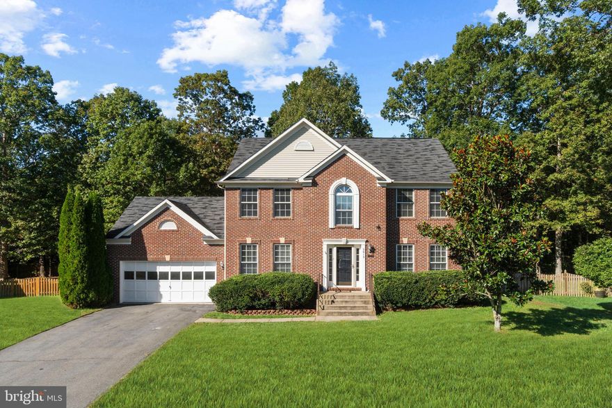 This lovely brick-front colonial boasts over 3,300 finished sqft on three levels. The main level features a hardwood entry, living room or home office, separate dining room, and family room with gas fireplace. The kitchen has stainless appliances, gas stove, upgraded countertops, center island, pendant lights, lots of cabinetry, and a spacious eat-in area. The upper level boasts 4 bedrooms, 2 baths, and a convenient upper-level laundry room with front loading washer and dryer. The spacious master suite has a walk-in closet, extra closet, vaulted ceiling, renovated master bath with separate vanities, tile flooring, jetted tub, and triple jetted tile shower. The hallway bath has double sinks. Mosey on down to the lower level recreational room with media equipment, full bath, 5th bedroom with large walk-in closet and storage room. This lovely home is situated on a private lot that backs to trees. Enjoy the rear fenced yard, stone patio, and shed. New carpet on main and upper levels, and neutral Agreeable Gray paint throughout! The Trane HVAC system was replaced (inside and out) in 2012. Only 2 miles to the nearest Virginia Railway Express (VRE) and close to the Spotsylvania Regional Medical Center, I-95, downtown Fredericksburg, tons of local shopping, and excellent restaurants.