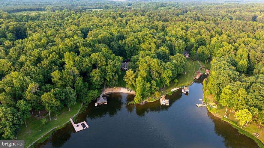 Just one look! That's all it will take for you to fall in love with this stunning waterfront home on the Public Side of Lake Anna.  Rarely will you find a waterfont like this! Sink your toes in your sandy beach and savor the long water views. Celebrate the end of a perfect lake day watching the sunset dazzle at the shore and from almost every room in the house.  Warm your nights around the fire pit with the moon sparkling on the water for as far as you can see. The magic continues as you stroll through this open floor plan with soaring windows to enhance your water views and an expansive kitchen that welcomes fellow cooks, friends, and family to gather.  No party is too large when you have a dining area by the kitchen plus an additional separate dining room. Enjoy more room to mingle on your wrap-around deck with a grill area. Did you notice the deck gazebo? Such a cozy spot to escape the sun or lounge on a rainy day. Make sure you check out the two (of 3) garage bays that have been converted to a game room, the teens will love hanging out there.  This home is thoughtfully furnished for entertaining, and comfort throughout, with 5 bedrooms (1 NTC), 3.5 baths, two family rooms, two dining areas, a lower-level bar, and a game room.  Never fear a power outage, with the integrated generator system. This home is located on the Southern end of the Public Side, where the lake water is clearer and deeper. This home is perfectly nestled in a small cove, where the water is shallow at the shore, making it easy for kids to play, and deepens gradually, offering a good depth for boating.  There are great restaurants, wineries, and breweries to explore in the area, This home is a very active rental. Buyer must honor existing rentals currently booked into November, and will benefit from the rental income.  All furniture available on a separate Bill of Sale, (excluding desk in Master Bedroom). Come enjoy this perfect Lake Anna location with an incredible waterfront and stunning lake views. Every day here will be a great day!