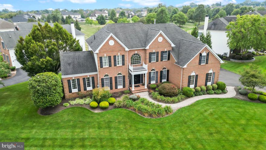 This beautiful home boasts 5 bedrooms and 4.5 bathrooms, located in the sought-after Northampton Hunt. Positioned on a corner lot backing up to an open area, it presents a captivating saltwater heated pool with a hot tub, as well as a paved patio adorned with expansive landscaping. The main floor greets you with a grand two-story foyer with an elegantly curved oak staircase, chair railings, and crown moldings and a balcony overlooking the family room. The gourmet eat-in kitchen features cherry cabinets, granite countertops, and a tiled backsplash. The formal dining room has a tray ceiling. In the family room, a striking vaulted ceiling and palladium windows frame a gas brick fireplace. The formal living room, currently repurposed as a game room, boasts wood paneling, crown moldings, and palladium windows. An inviting conservatory offers oversized palladium windows, and there's also a spacious home office. Upstairs, the second floor includes a luxurious Master Suite with a sitting area, tray ceiling, and a generous walk-in closet equipped with cherry wood built-in organizers. The master bath includes a Jacuzzi, an expanded shower stall with glass doors, and a double vanity. There is a princess suite with its private bathroom and there are two additional roomy bedrooms that share a Jack and Jill bathroom. The lower level features a finished basement with a wet bar, an exercise area, one bedroom, a bonus room that is currently serving as a music room with built-in cabinets, a full bath, and a storage area with bilco doors. Additional features of this exceptional home include hardwood floors, recessed lighting, a dual staircase, a three-car garage, three-zone HVAC, a 75-gallon water heater,  fully paid-off solar panels, and irrigation system. Conveniently situated near major roads, shopping, restaurants, and within the award-winning Council Rock School District.