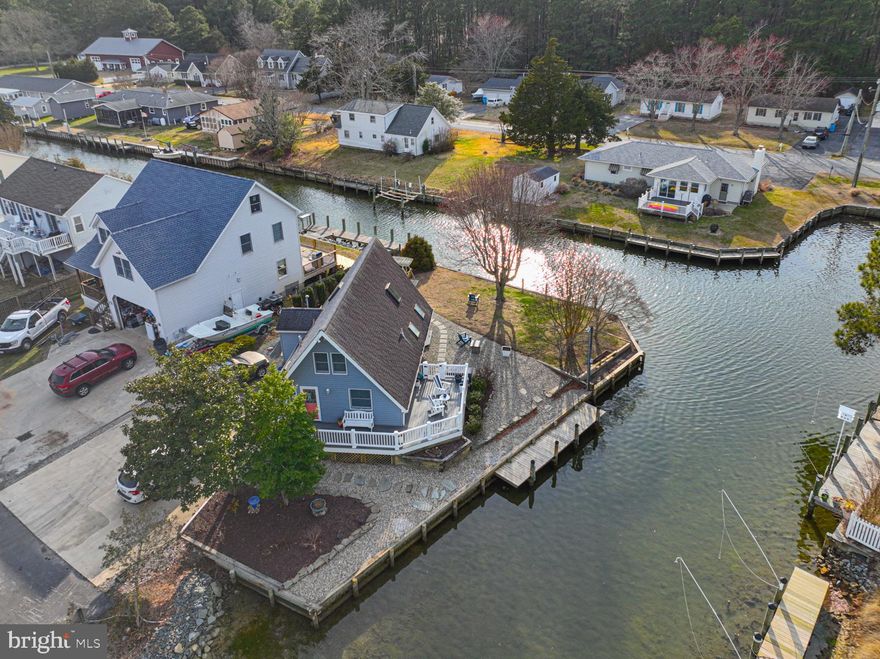 Adorable waterfront home in great West Ocean City neighborhood!   This home is situated at the end of New Quay Rd on a .26 acre lot with approximately 160 feet of canal frontage and direct access to Isle of Wight Bay.  Enjoy the outdoors on the wrap around deck overlooking  the spacious yard and beautiful water views.  Other outdoor features include a concrete patio, beautiful landscaping, plenty of off street parking on the concrete driveway, and attached utility shed.  Absolutely charming interior with updated kitchen & baths, first floor bedroom & full bathroom, and ceramic tile flooring throughout the first floor living areas.   The second floor offers a 2nd bedroom, full bath, large closet, and accessible attic- eave storage.   Prime location- close to endless shopping, dining, and entertainment options, the resort town of Ocean City, as well as the natural beauty of Assateague National & State park beaches .  This is a perfect investment opportunity, 2nd home, or primary residence.