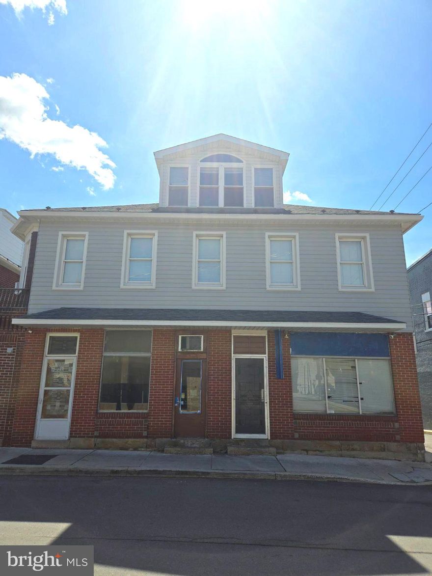 Unique opportunity to invest in Downtown Frostburg! This building previously held a popular bakery and is ready for its new owner and new venture! This space is ready to be transformed into its next commercial enterprise as it is currently surrounded by established businesses and conveniently located to Main St. This space does have a fire suppression system and hookups for most equipment in the small food and beverage space but can be converted into retail, office, etc. Besides the commercial space this building also hosts a 2 bedroom apartment! With lovely hardwood floors throughout, bay window, lots of natural light, cedar closets, laundry in bedroom, half bath en suite, and a VERY spacious 3rd floor loft this apartment is quite impressive! Investors could easily prepare the spaces and rent both units or owner operators could have the convenience of additional rental income or a nice spot to live right next to their business. This property is being sold AS-IS with the equipment that is left being removed. Get your showing on the books to see if this space is perfect for you!